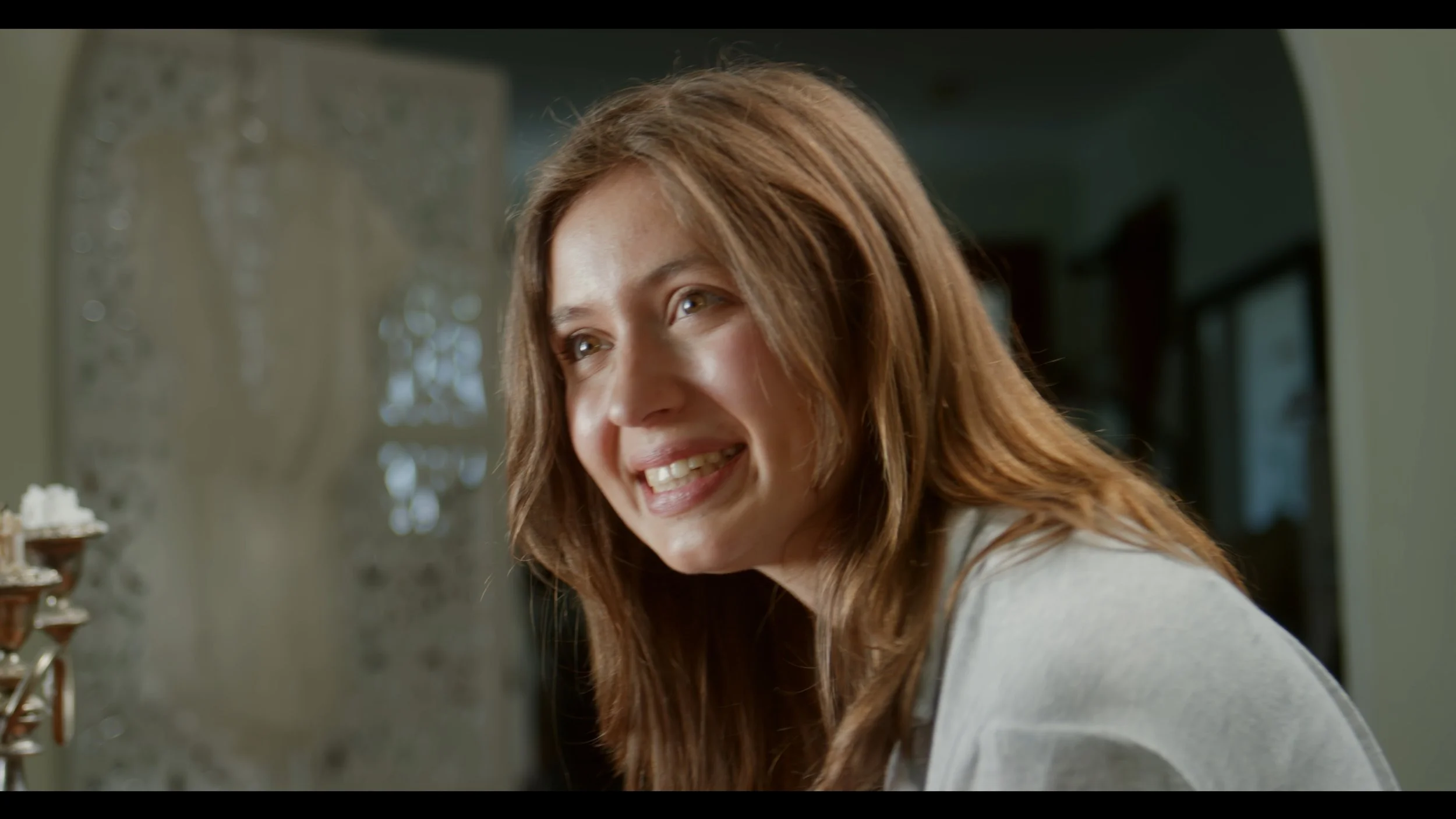 Smiling woman with long brown hair indoors