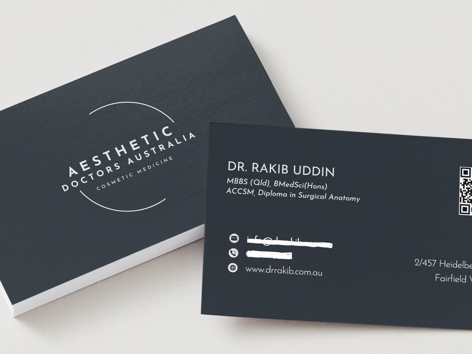 Business cards for Aesthetic Doctors Australia. They have a black background and white text.