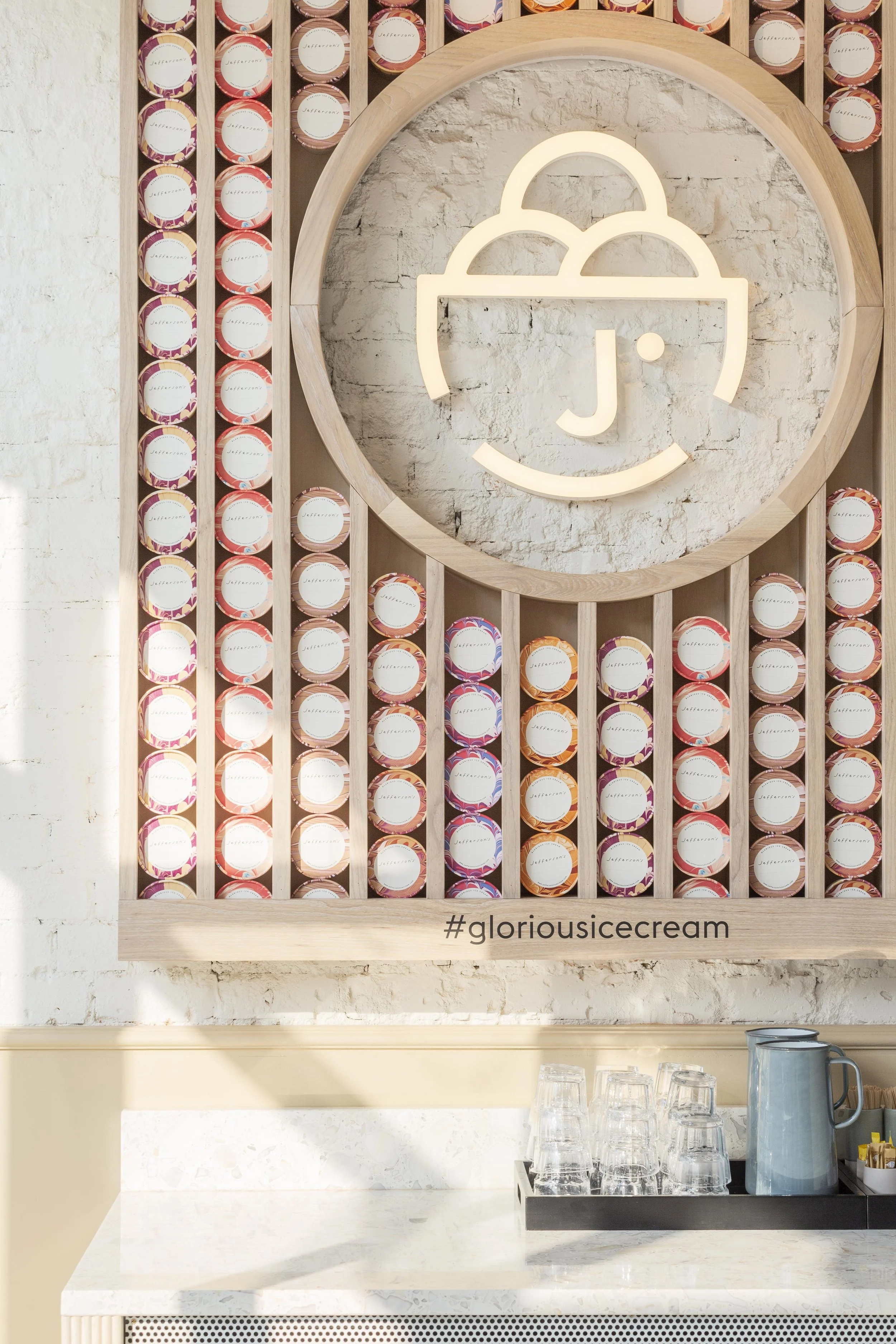 The Jefferson's Ice Cream logo illuminated in neon