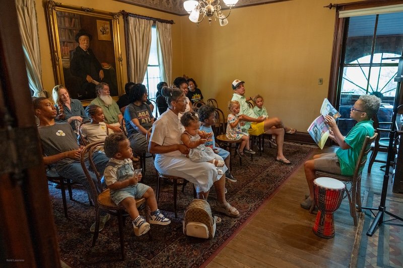 Ryan reading MSRC book with drum.jpg