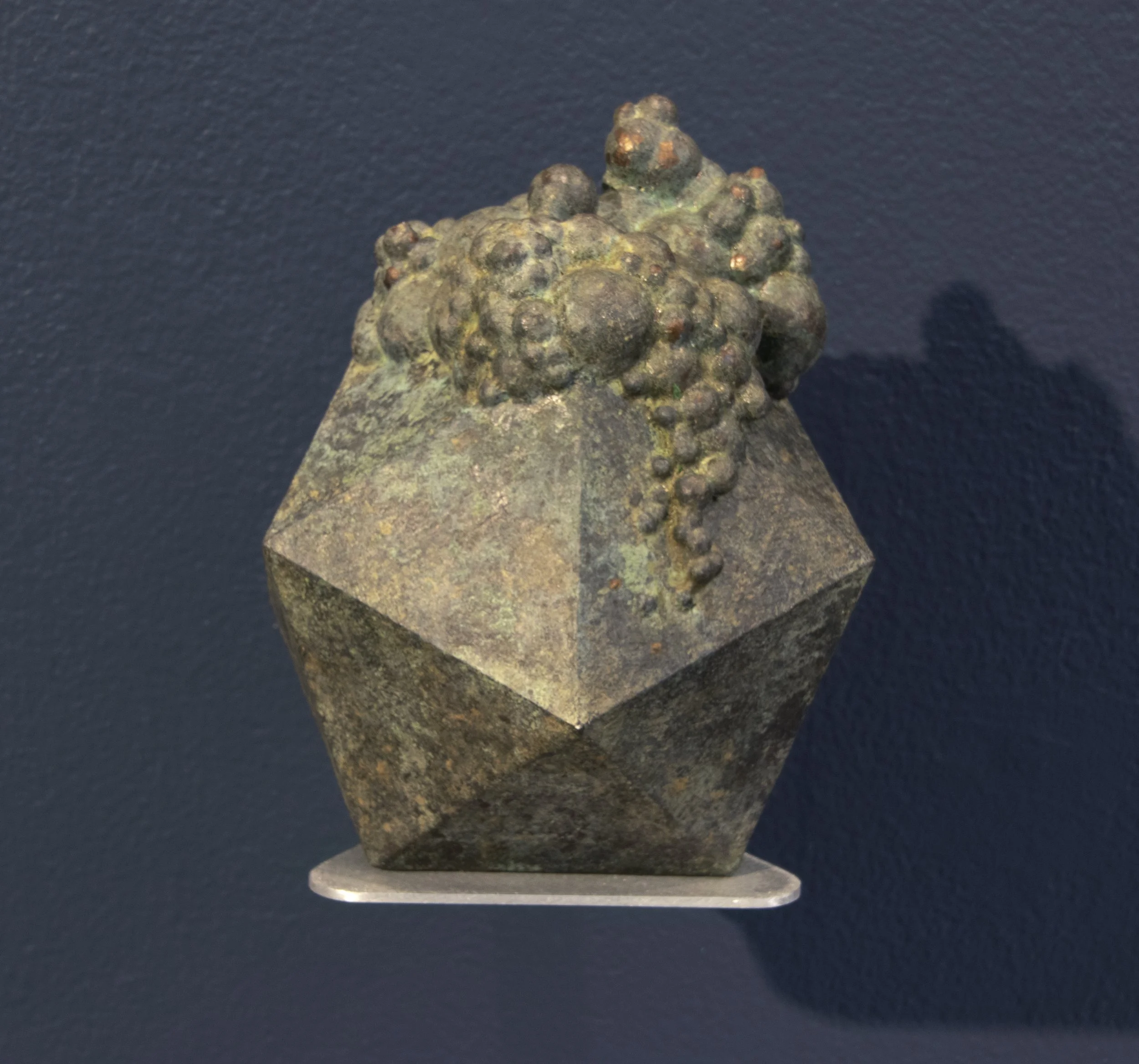 Affirmation of Life: Water, 2019. Patina, PLA-Plastic, Aluminum shelf. 4" x 4" x 4" Icosahedron