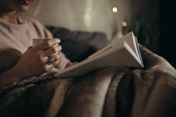 woman drinking tea reading book