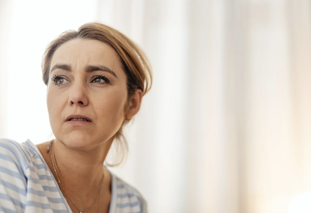 woman looking into distance with concerned expression