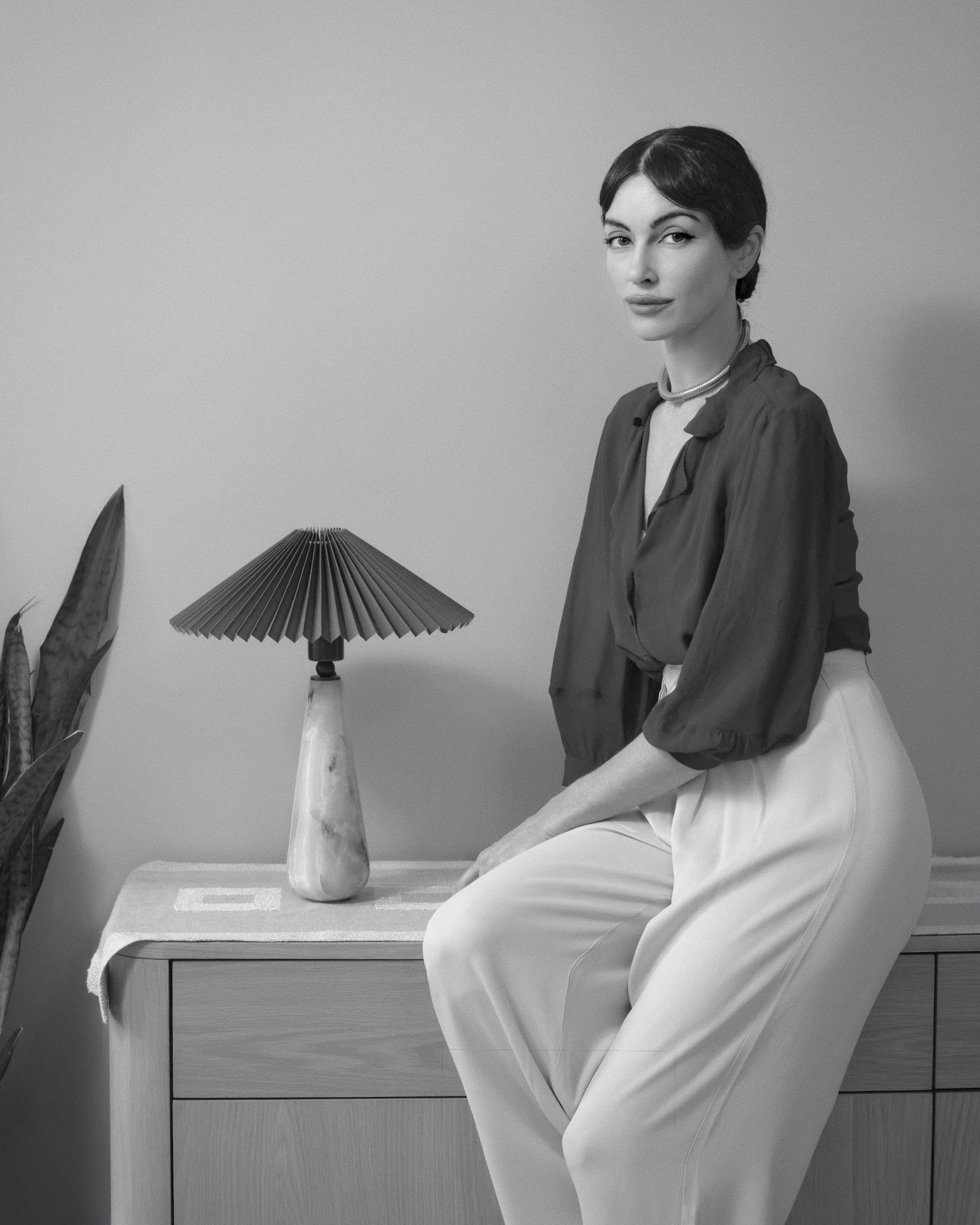 designer tyler snazelle artist founder of callisto lighting tyler snazelle portrait sitting with gemini lamp