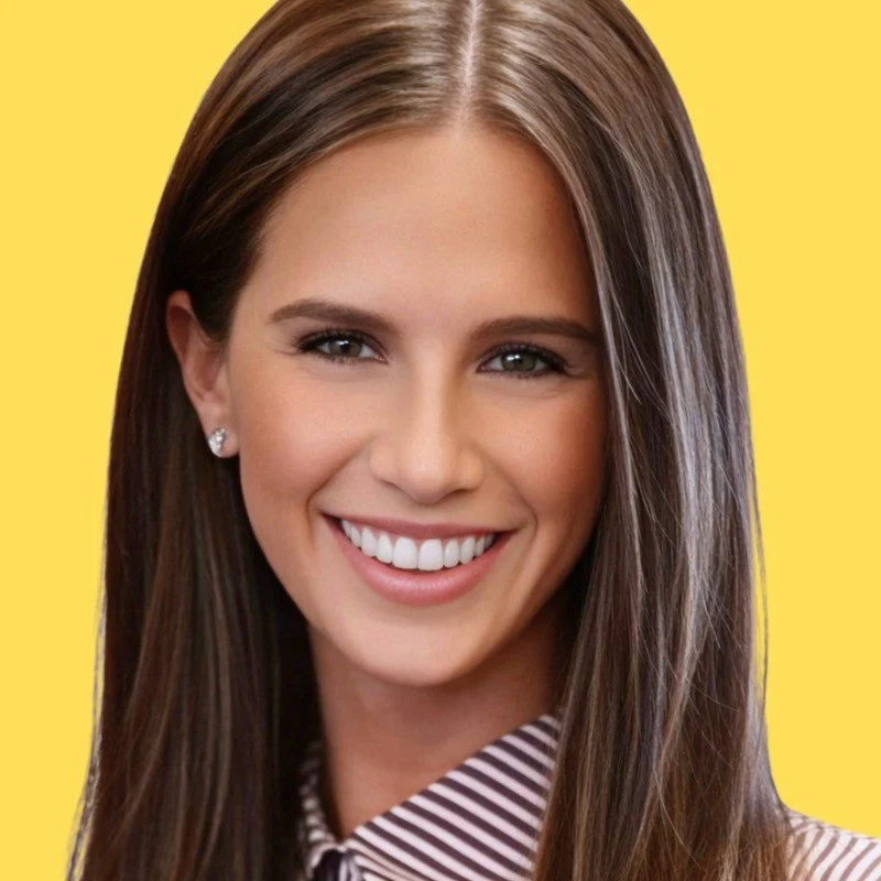 Close-up of a young woman with smiling face, brown hair, and small earrings, wearing a striped shirt against a blue background.