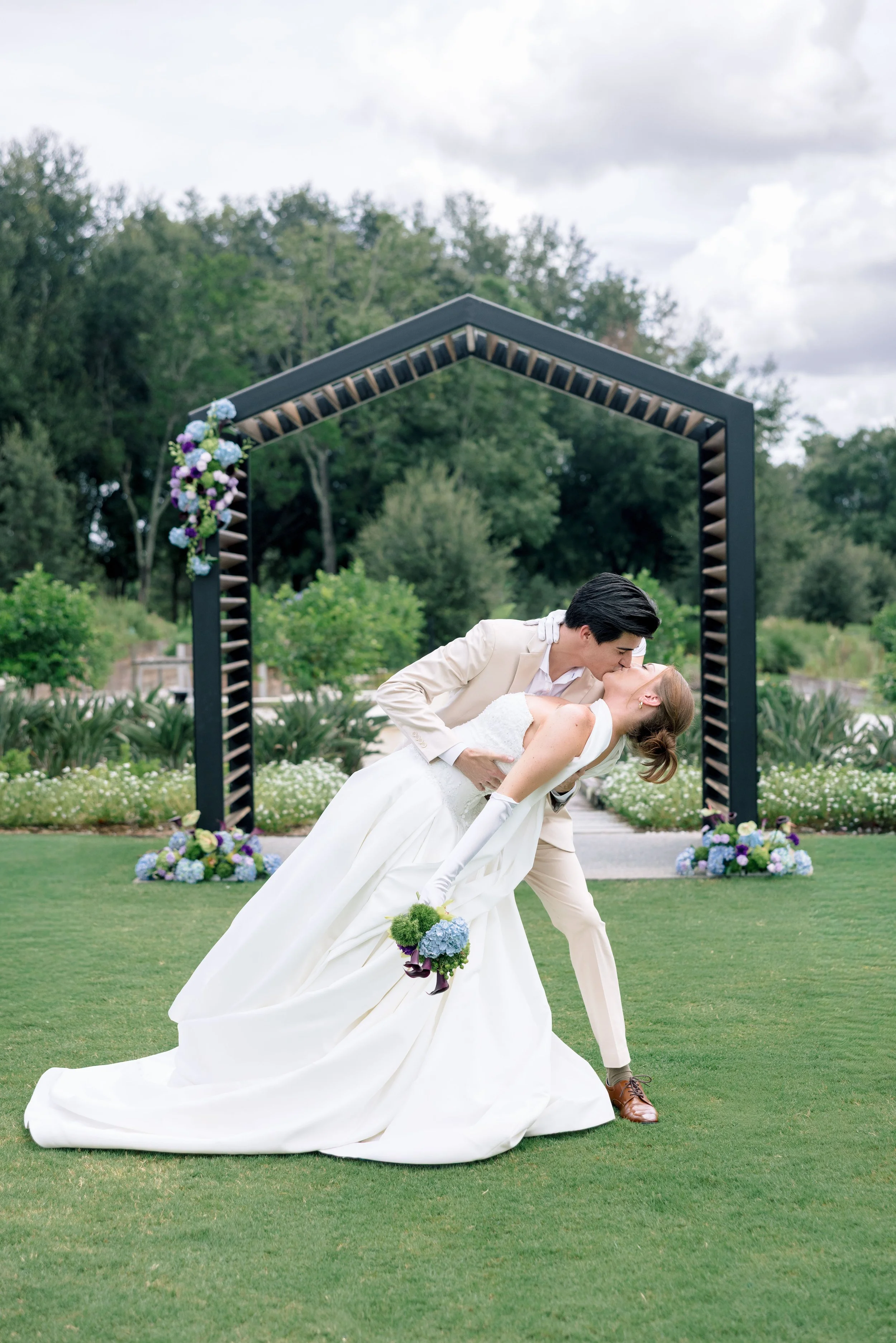 Bride and groom kiss at ceremony at Bonnet Springs by Lakeland wedding photographer