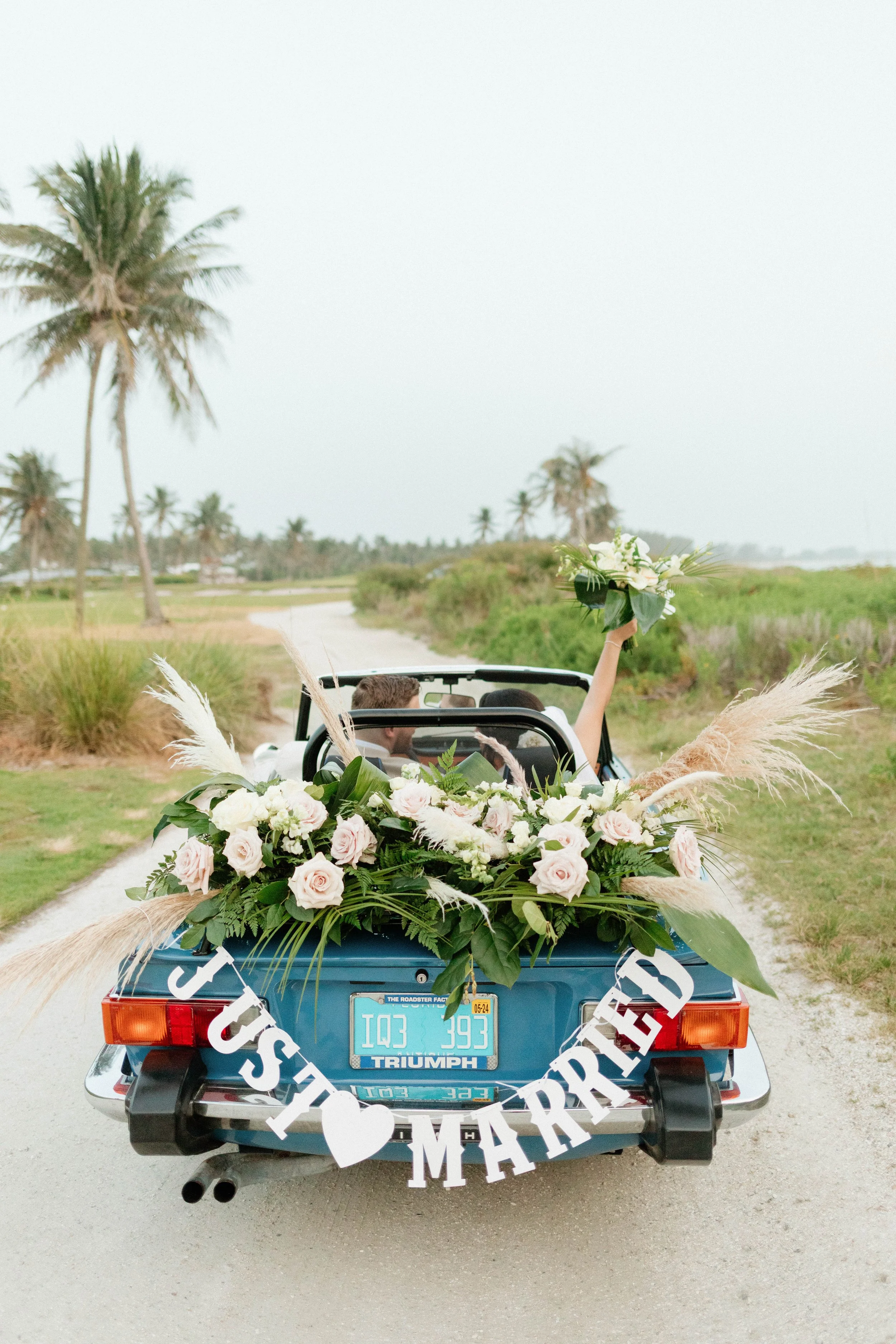 Bride and groom in vintage car at South Seas Island Resort wedding photographer