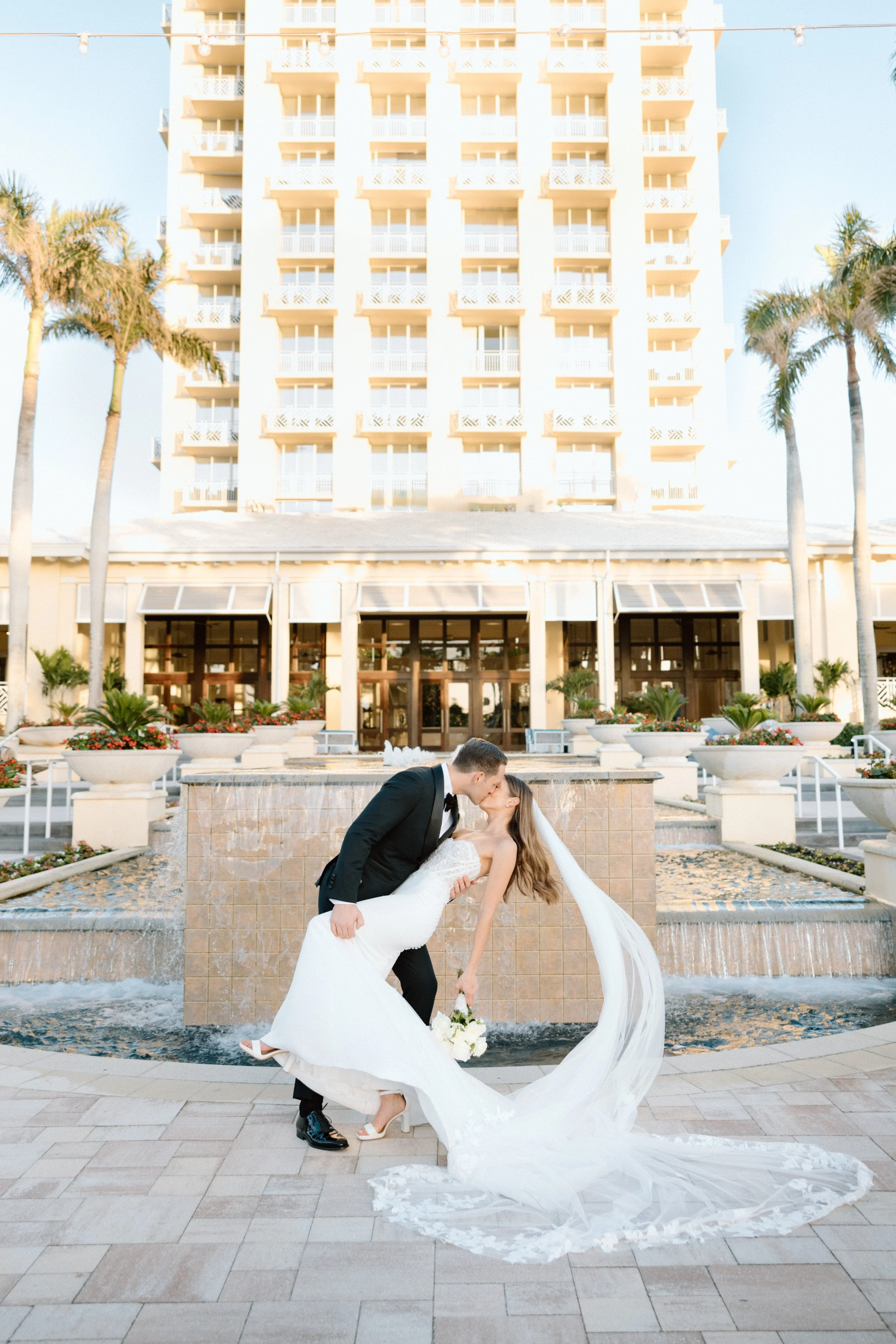 Bride and groom kiss at Hyatt Regency Coconut Point Resort and Spa by Naples wedding photographer