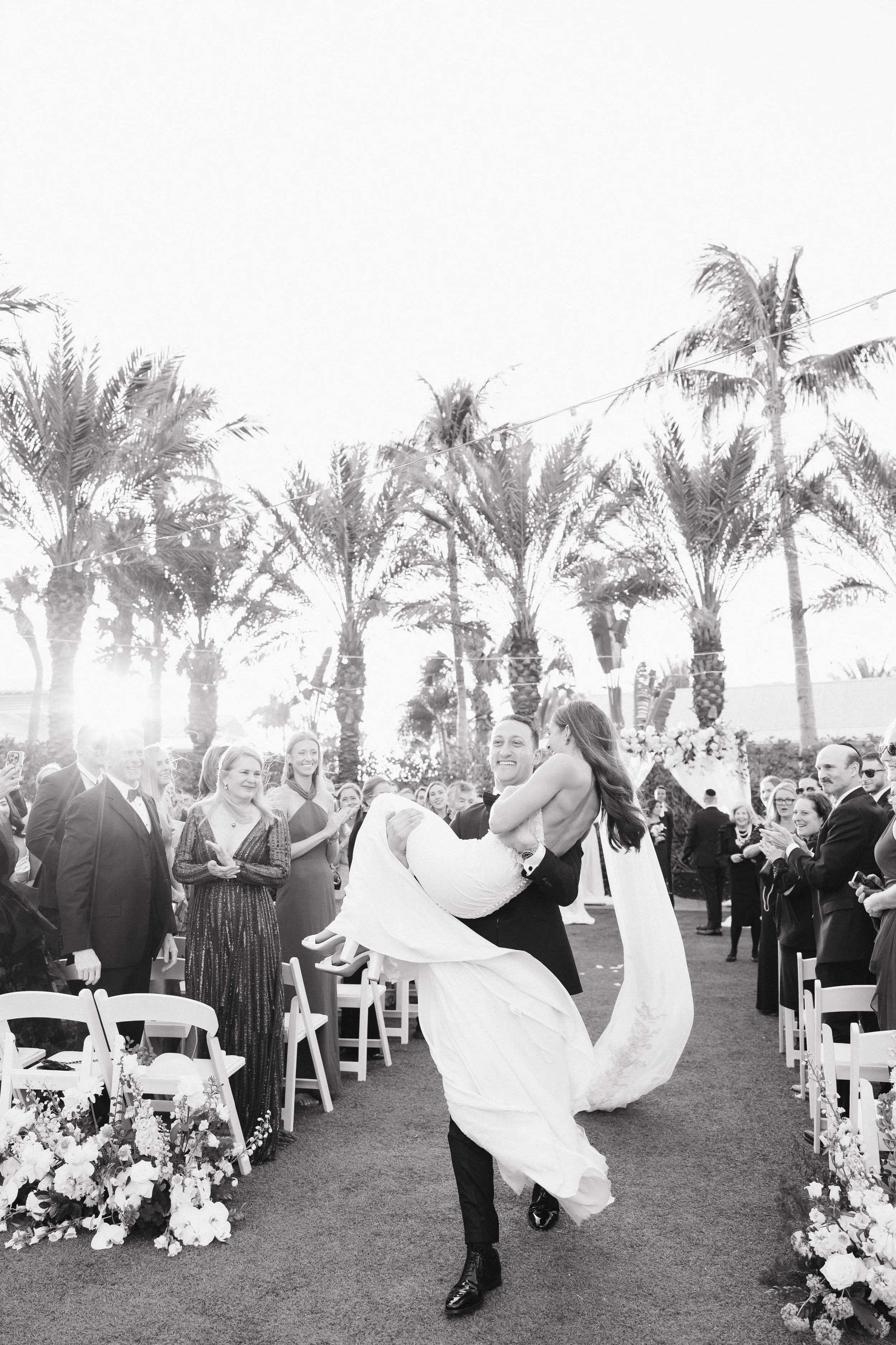 Groom Carrying Bride During Recessional