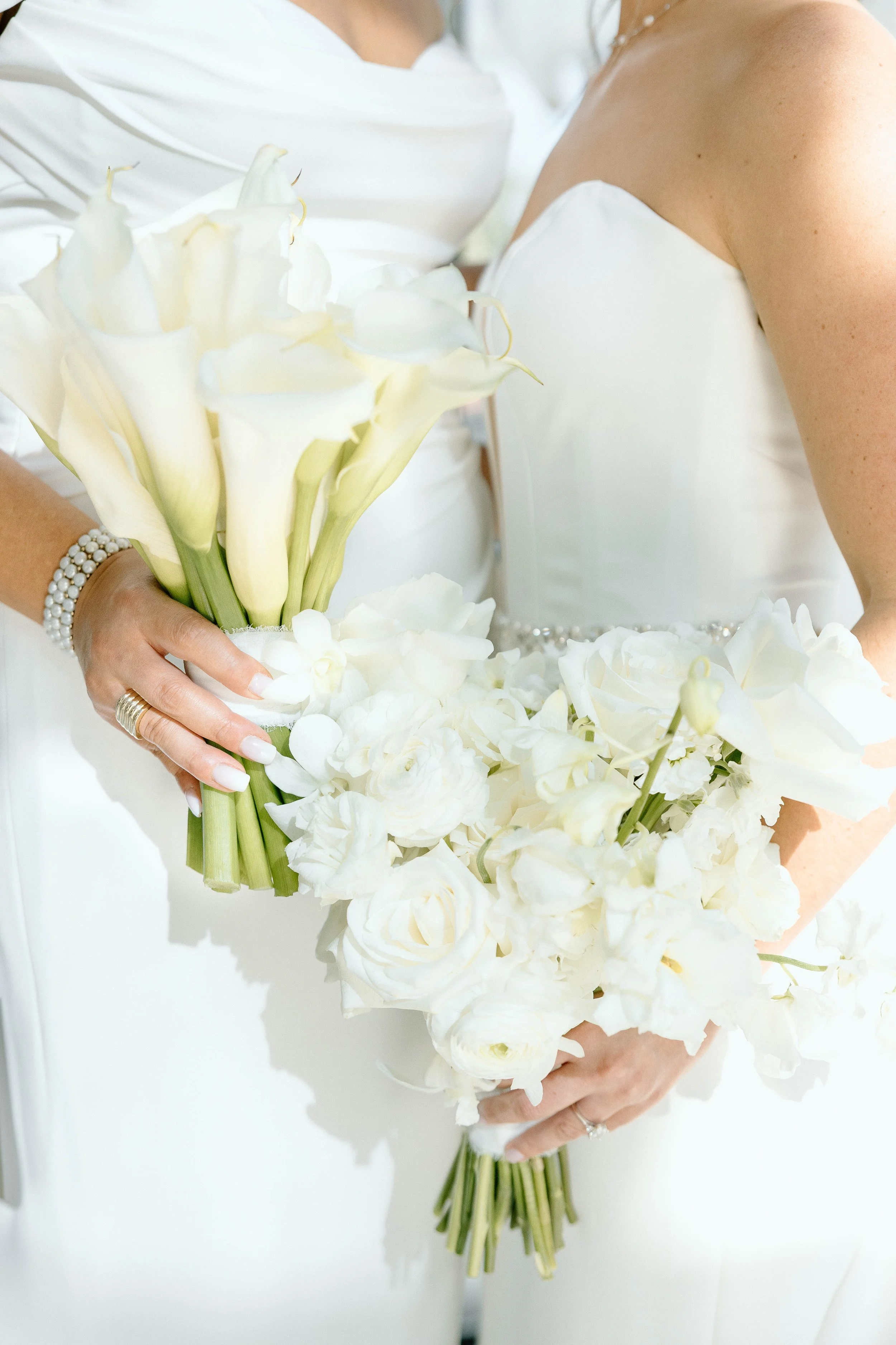 Brides holding bouquets together by Fort Myers Wedding Photographer at the Alderman House by Mizner