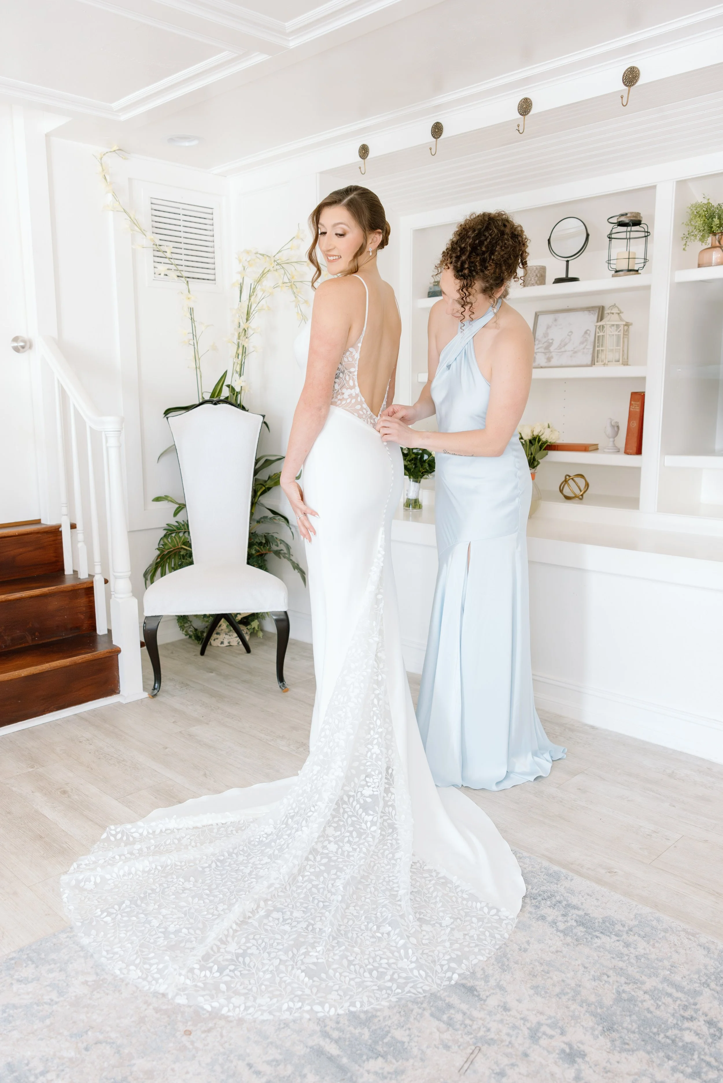 Bride gets into wedding dress at Grace River Island Resort by wedding photographer Fort Myers