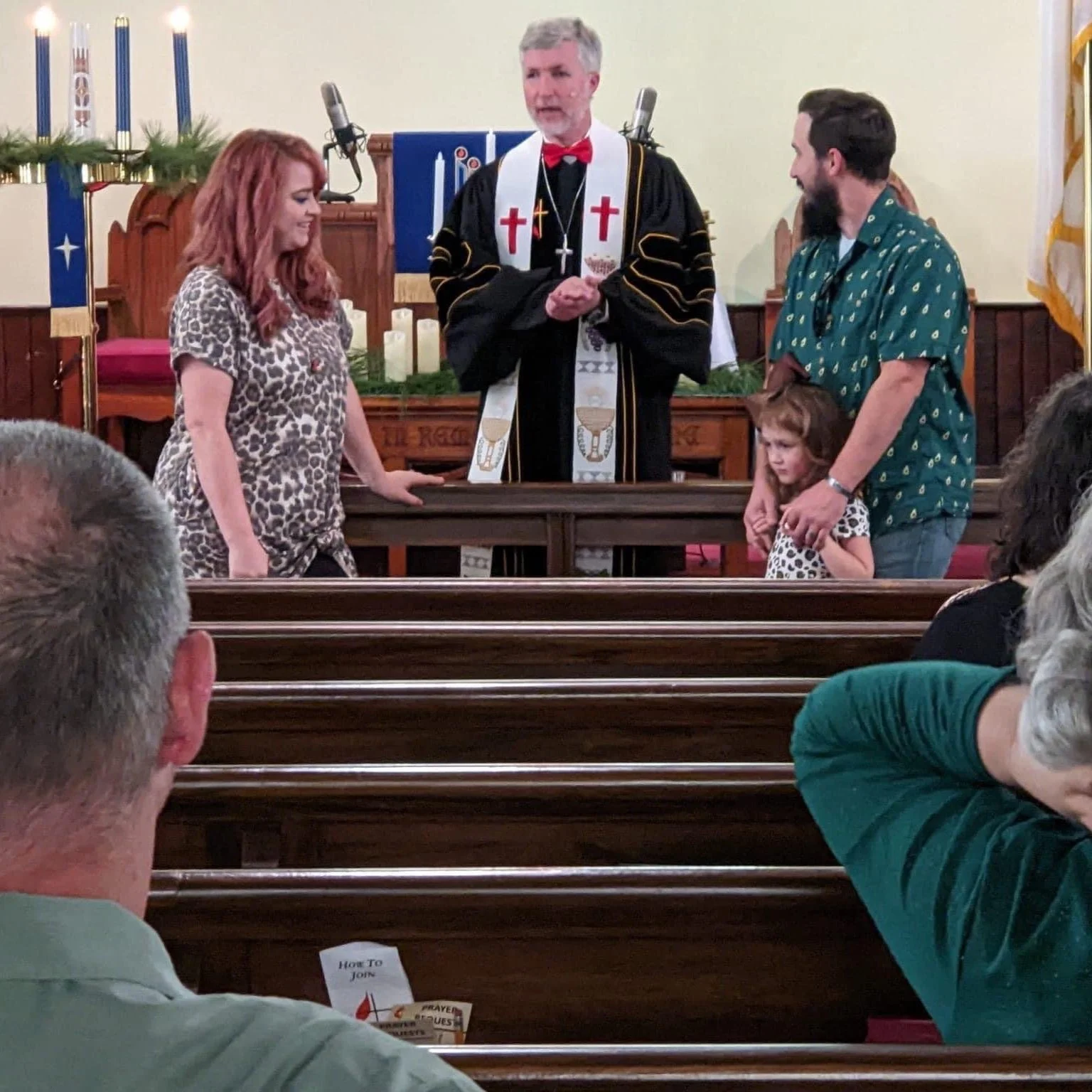 This is a photo of the pastor welcoming a new family to the church.