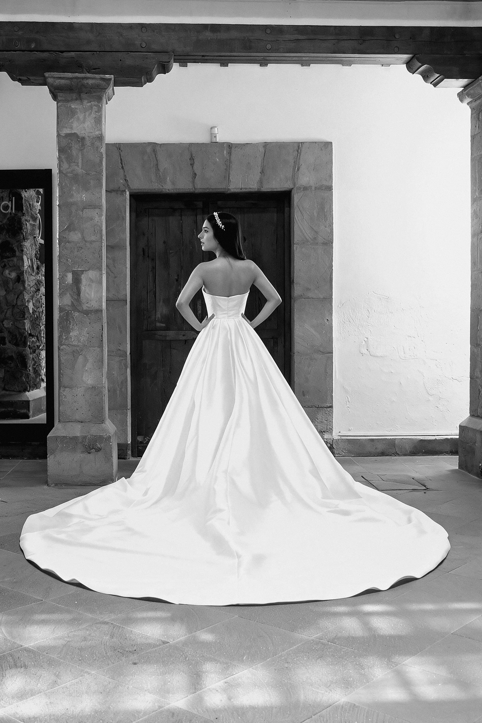 Espalda del vestido de novia Love en satén con la sobrefalda y cola extendida.