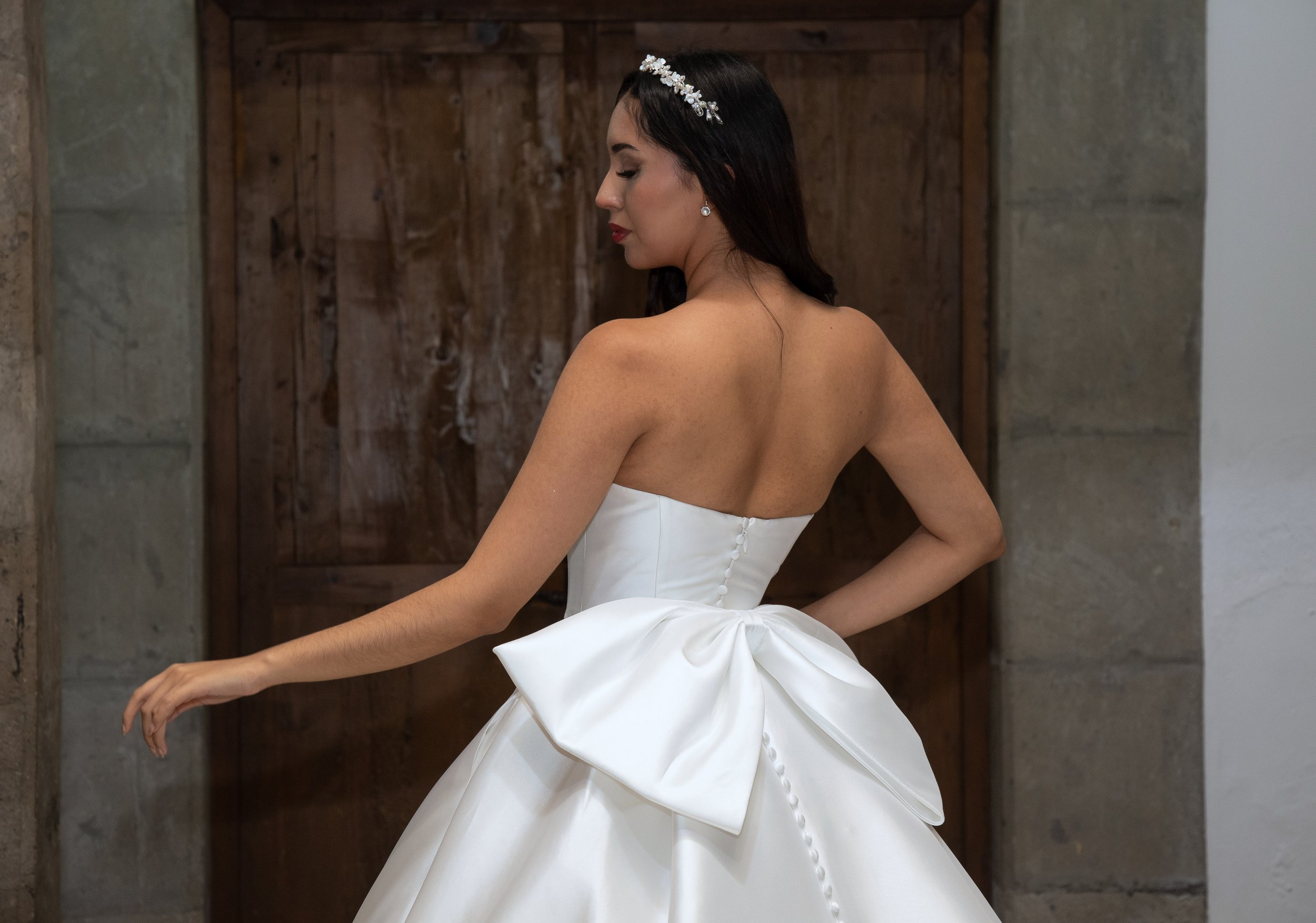 Vista de tres cuartos de la espalda del vestido Lauren con moño de satén..jpg
