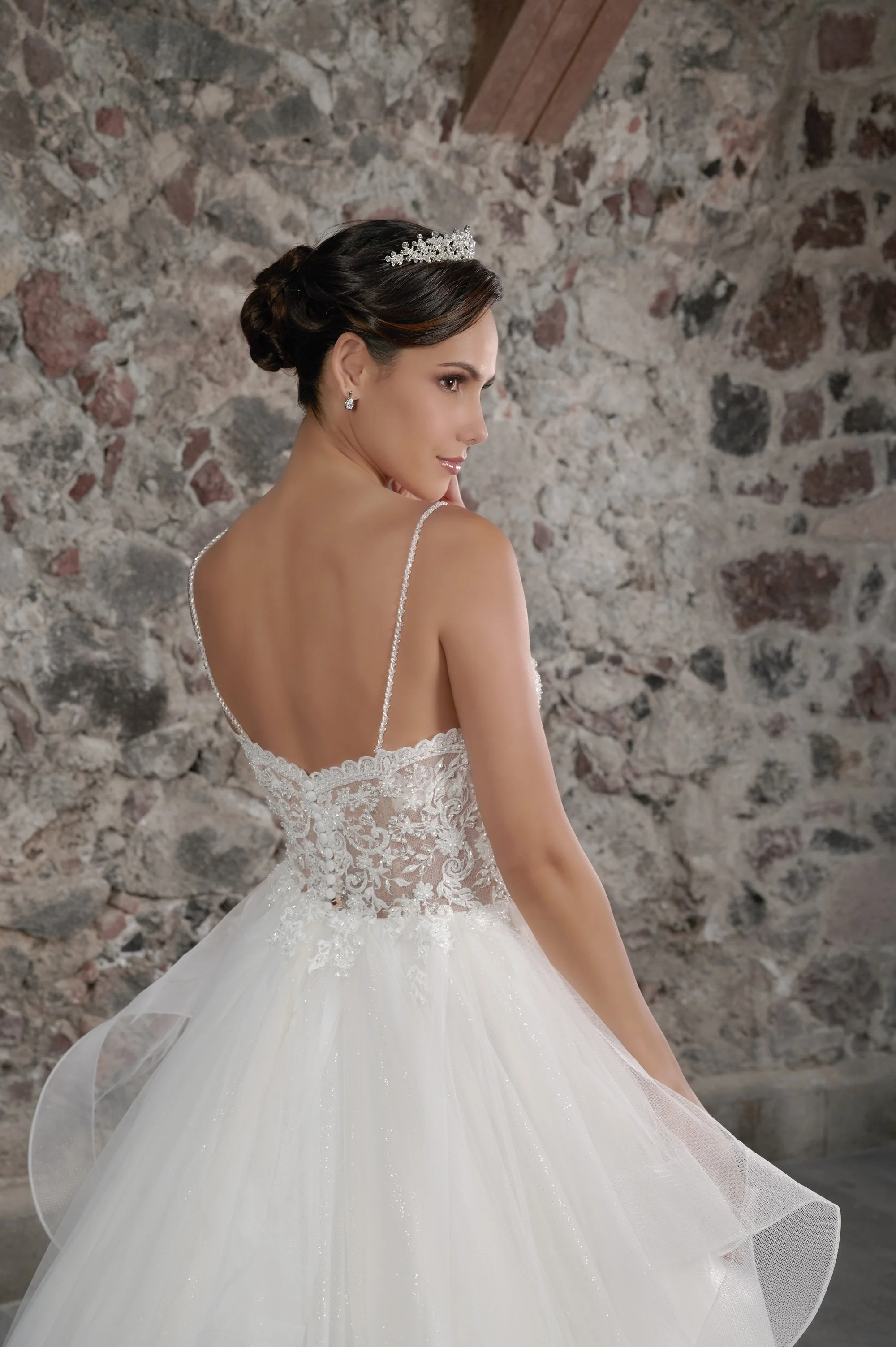 Espalda descubierta del vestido de novia Colibri con falda de tul en capas y cola larga.