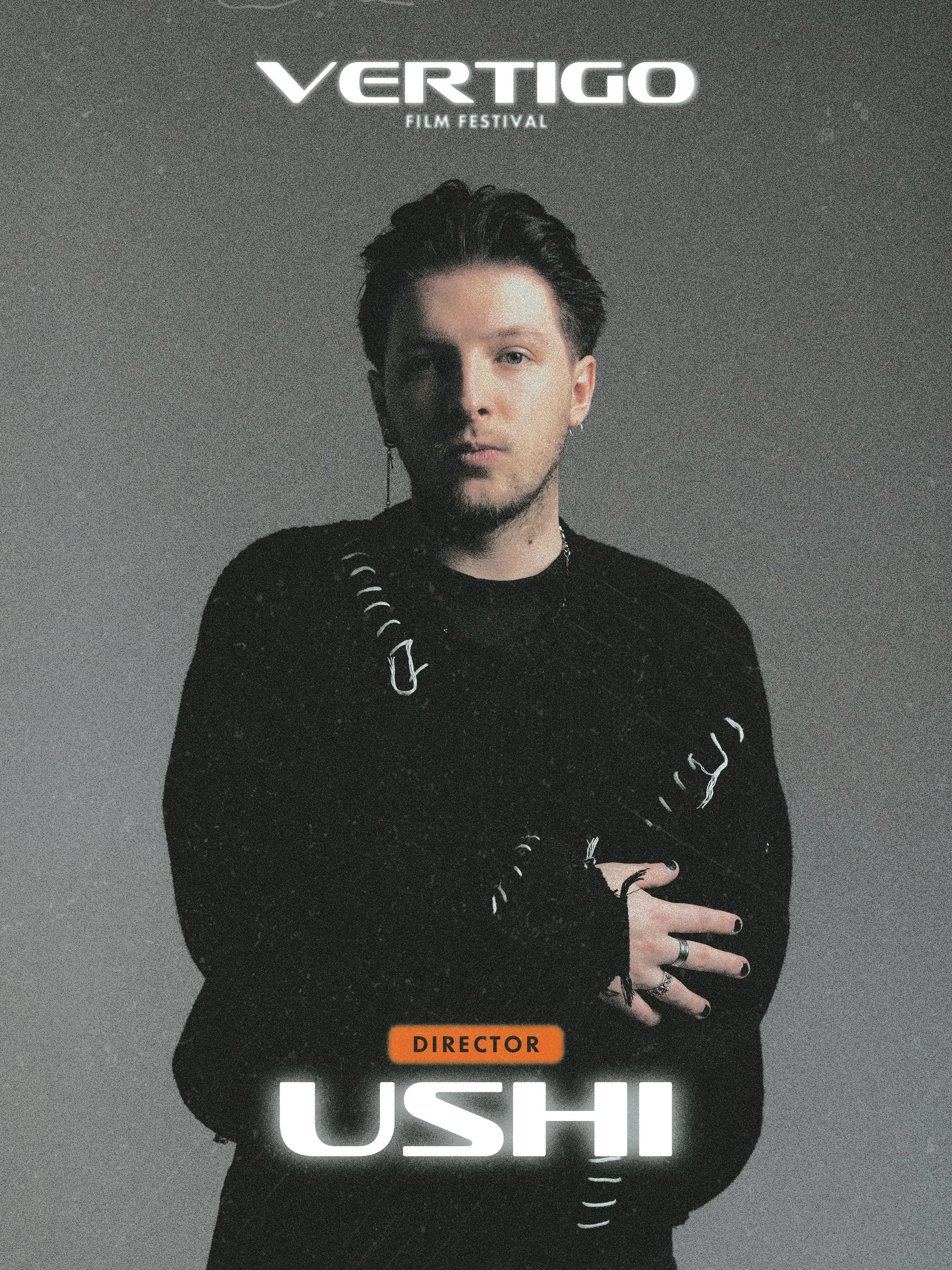 Promotional poster for the Vertigo Film Festival featuring a young man with dark hair, wearing a black distressed shirt and silver rings, against a simple dark background. The text includes "VERTIGO" at the top, "FILM FESTIVAL" below it, and a label "DIRECTOR" in orange, with a partially visible name at the bottom.