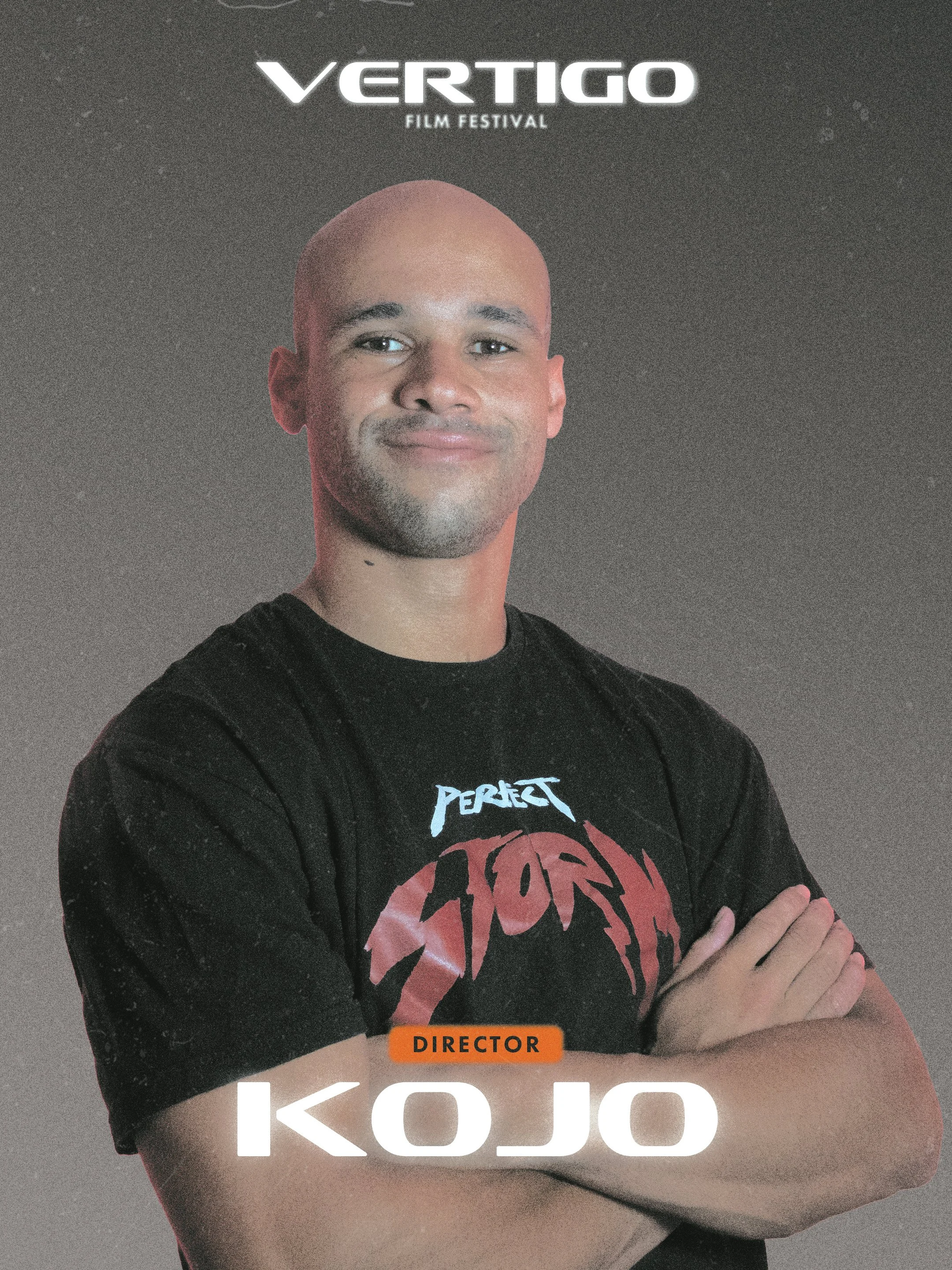 A person with a shaved head wearing a black t-shirt featuring a red and white graphic design, standing with arms crossed in front of a dark background. The word 'DIRECTOR' is displayed in an orange box, and the name 'KOJO' is written in large white letters at the bottom of the image. The image appears to be a promotional or official photo for the 'Vertigo Film Festival.'
