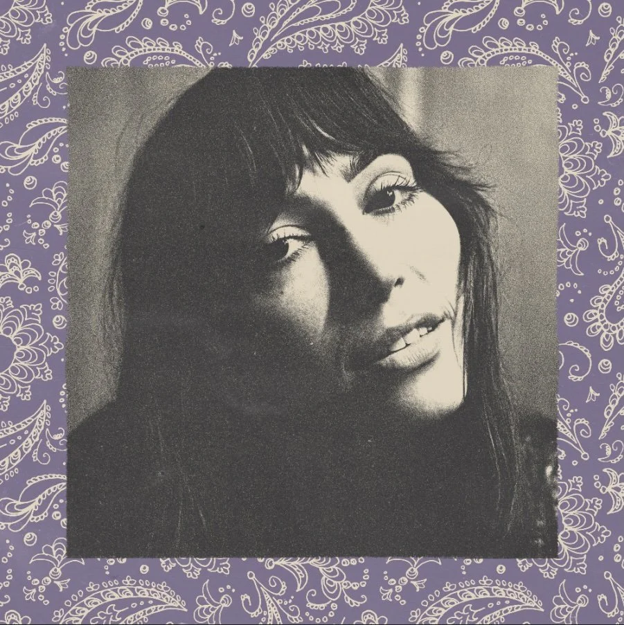 Black and white vinyl cover. A portrait of Abigail Rose with dark hair, smiling slightly, with purple paisley-patterned background.