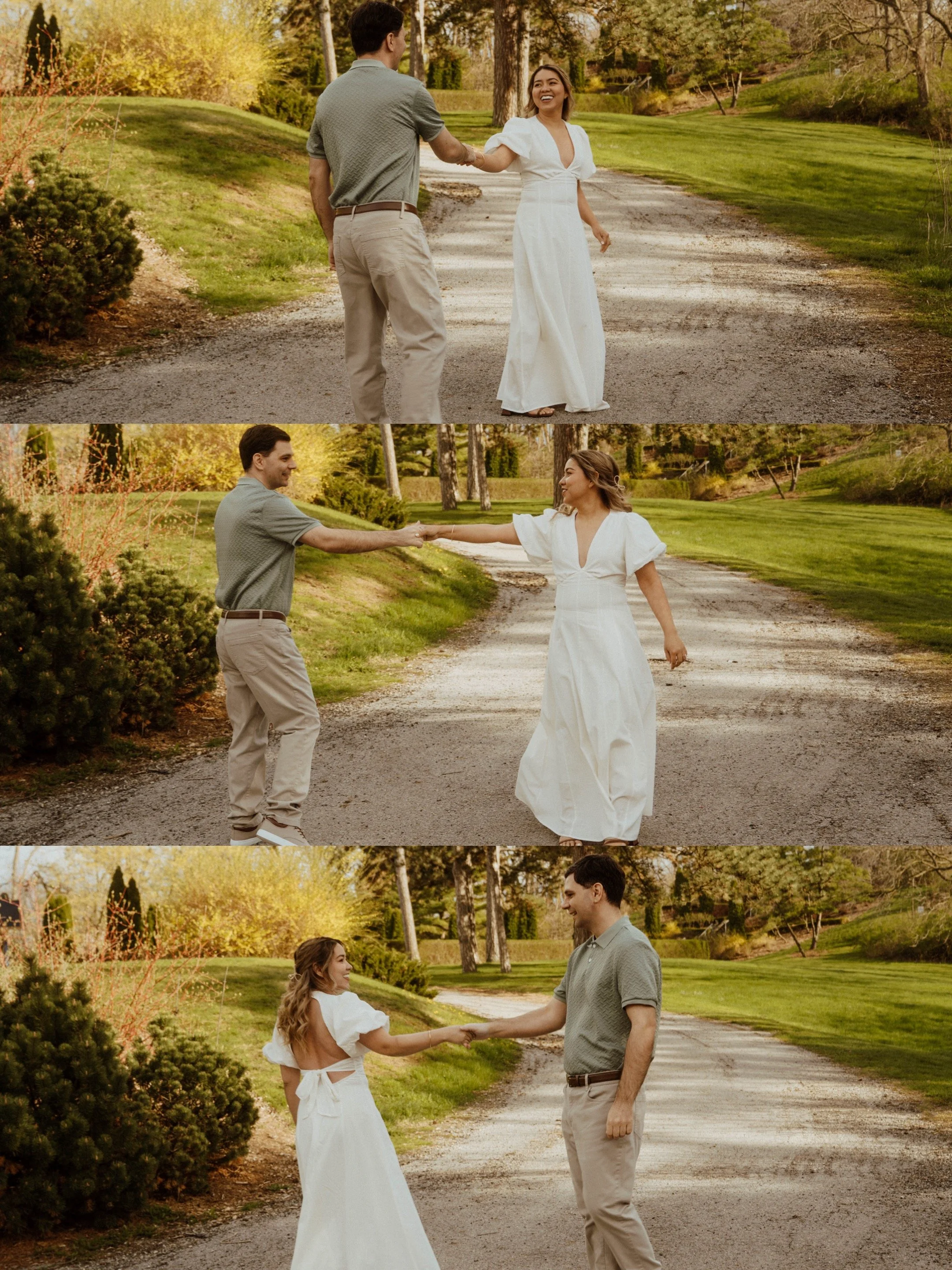 Couple holding hands and spinning during a romantic engagement session at Battlefield Park in Hamilton, Ontario, captured on a scenic garden pathway in golden hour light