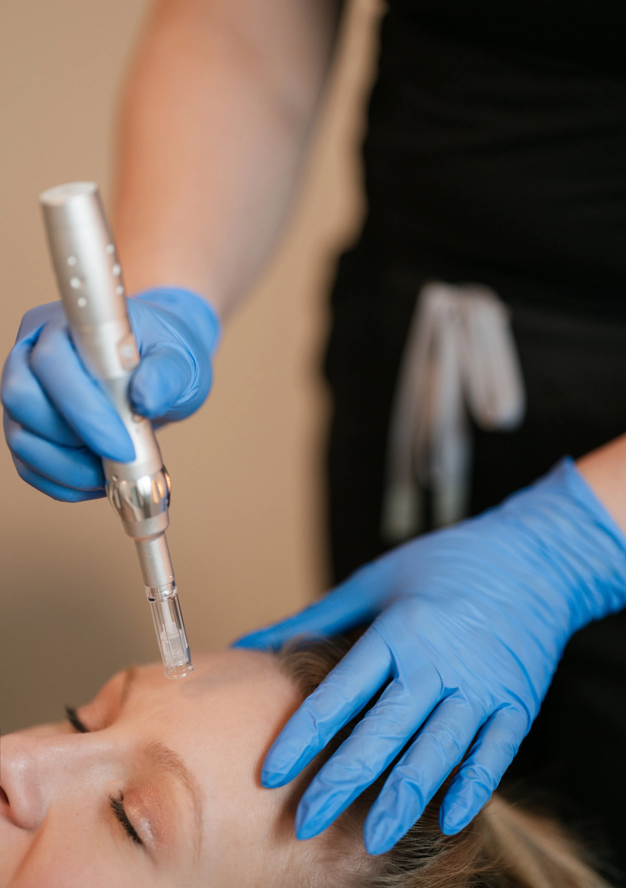 Close-up branding photo of a luxury skincare treatment with professional wellness equipment and soft studio lighting.