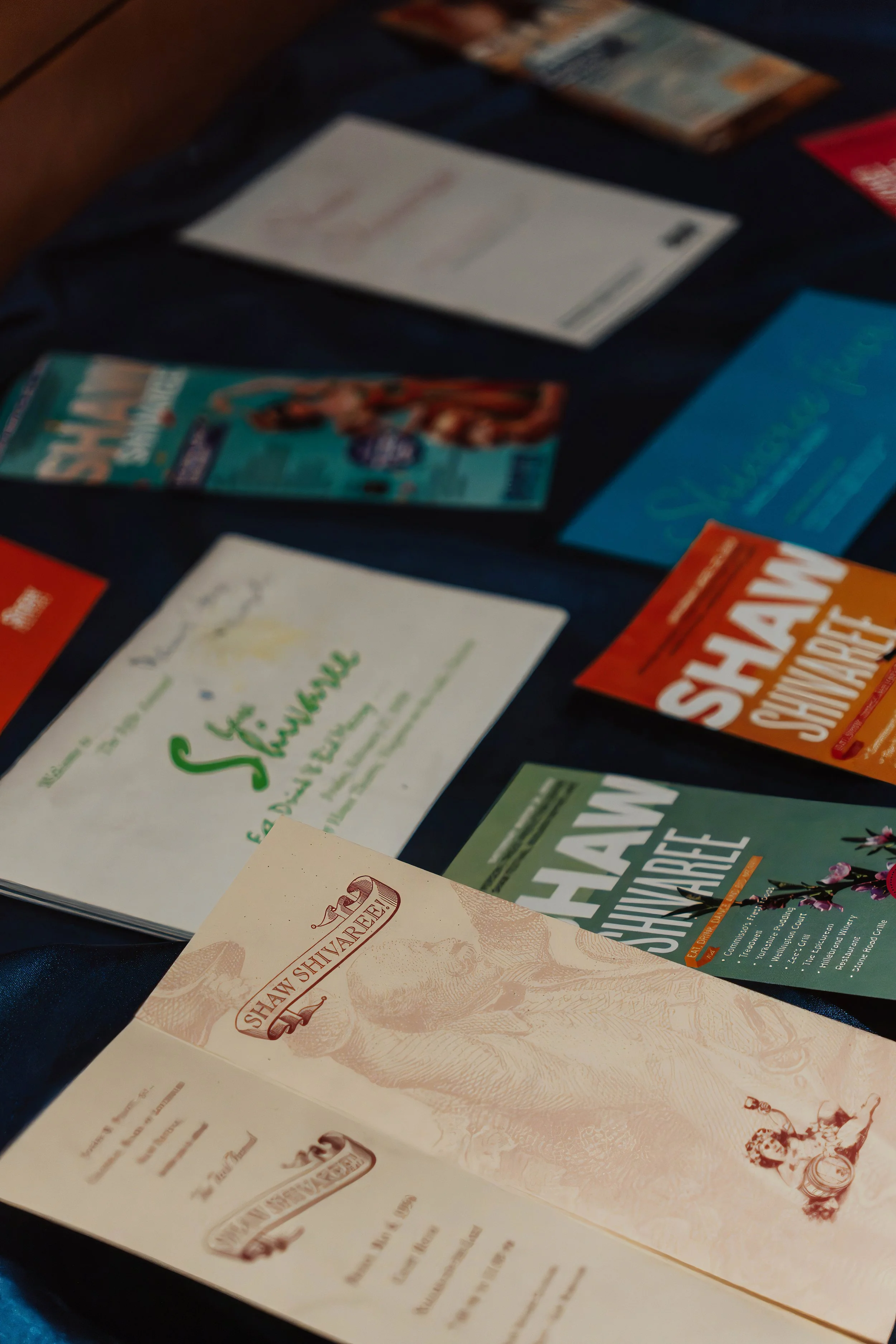 Display of various brochures and flyers on a dark table.