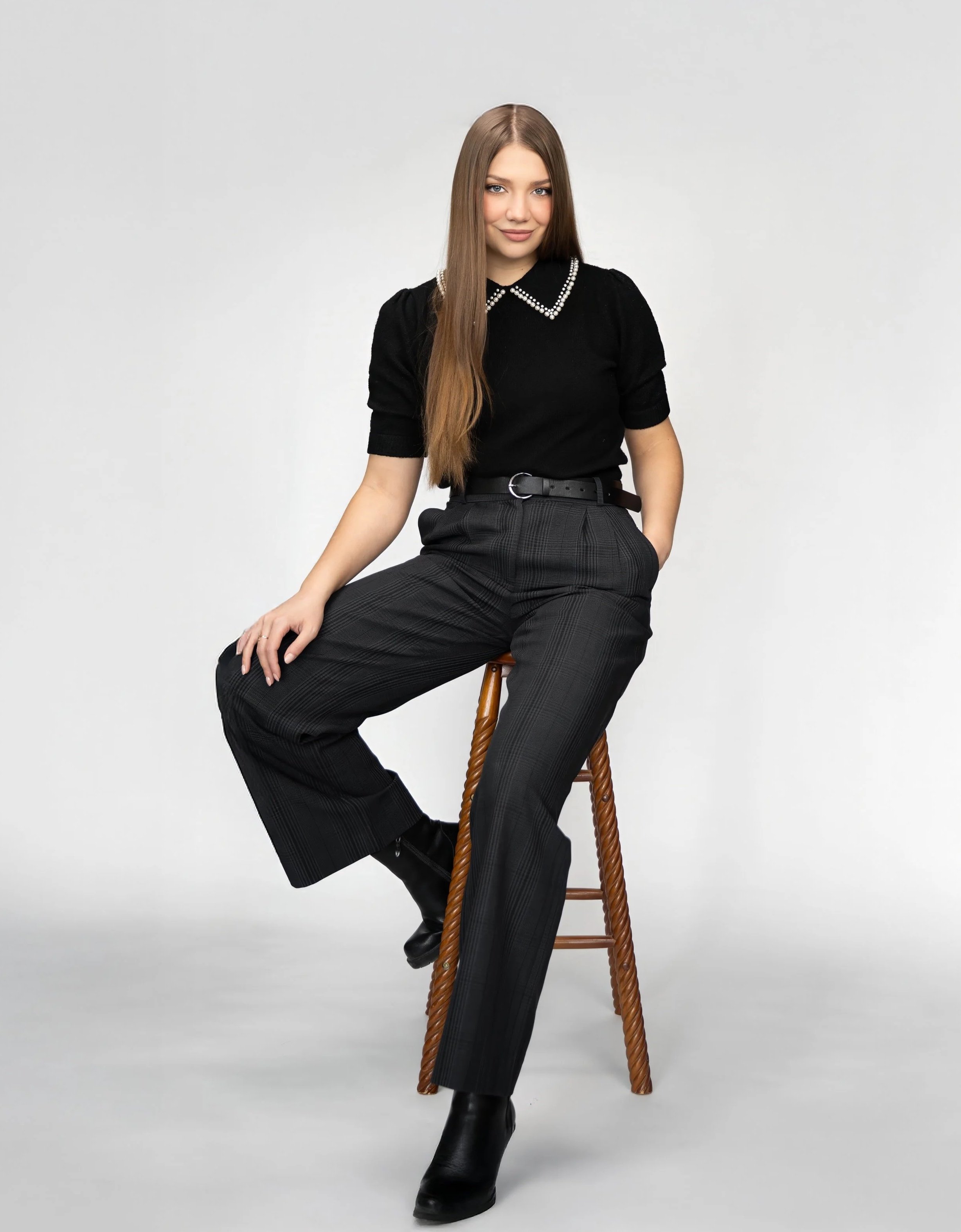 Toronto makeup artist branding portrait of Masha seated in studio, clean minimal background showcasing personal brand, confidence, and professional identity