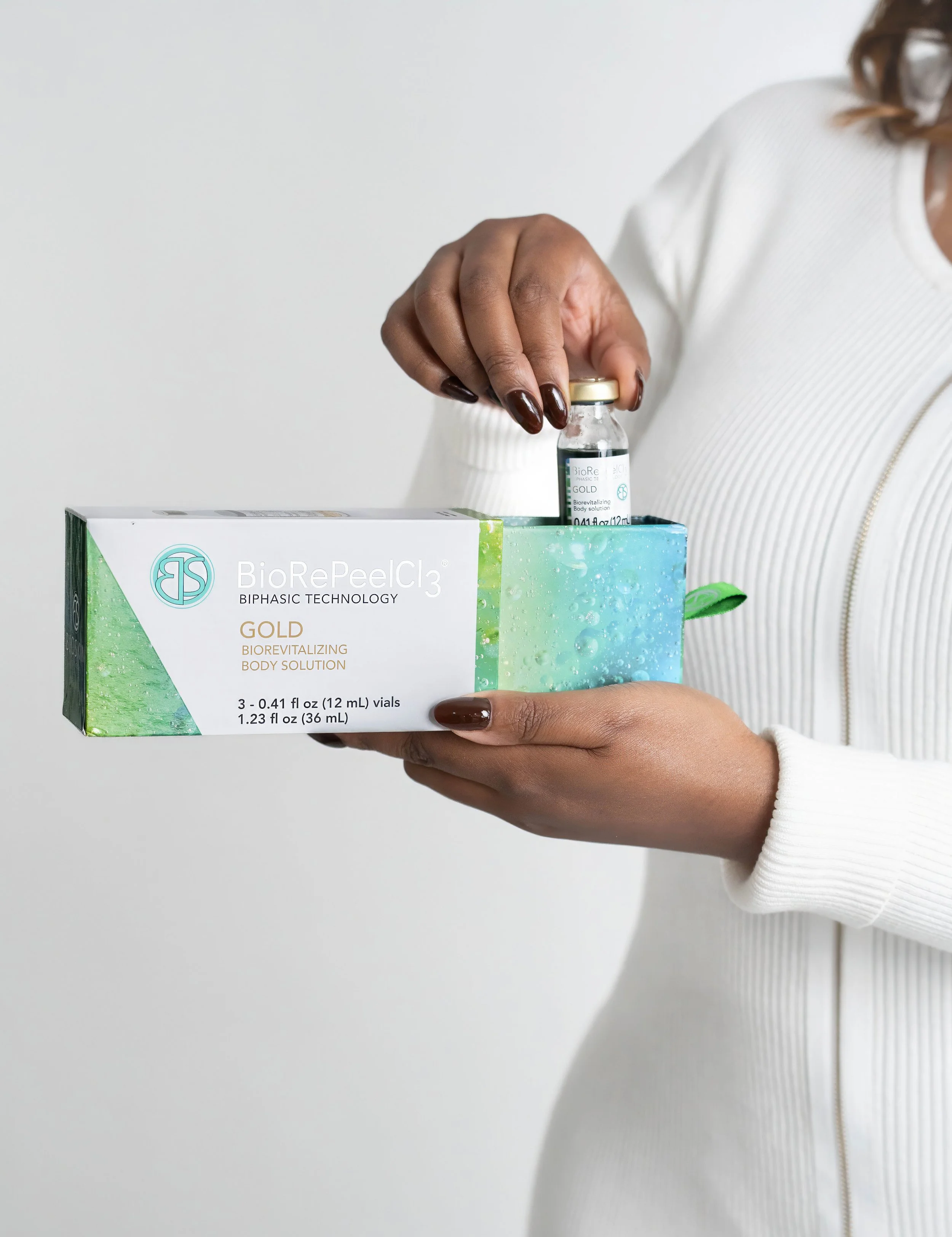 Toronto product and branding photography of BioRePeelCl3 Gold biorevitalizing solution with vial, clean white studio background, soft lighting, medical aesthetics and skincare content creation style