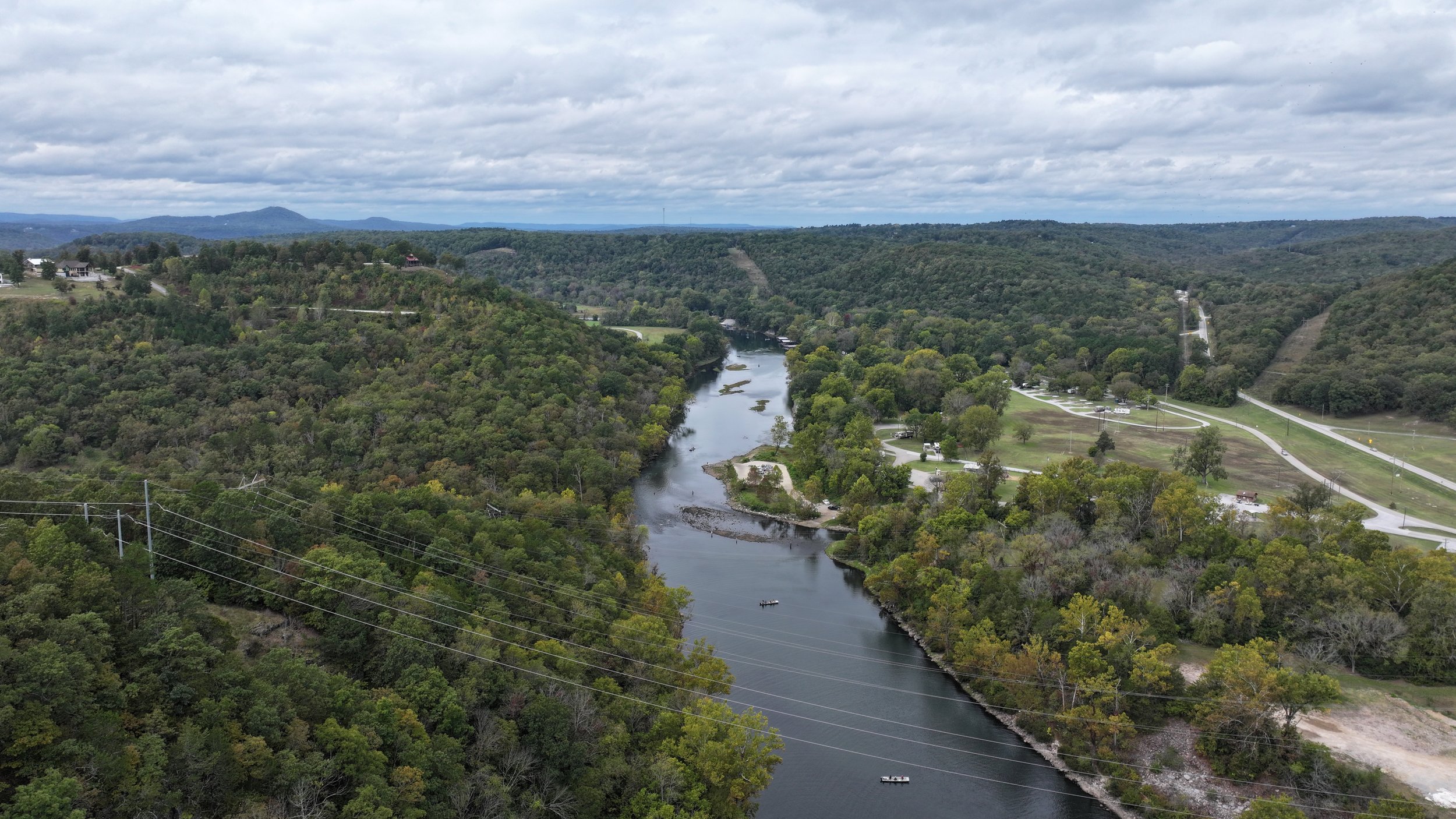 An aerial view of a serene river flowing undisturbed through its natural course, surrounded by scenic landscapes and tranquility.