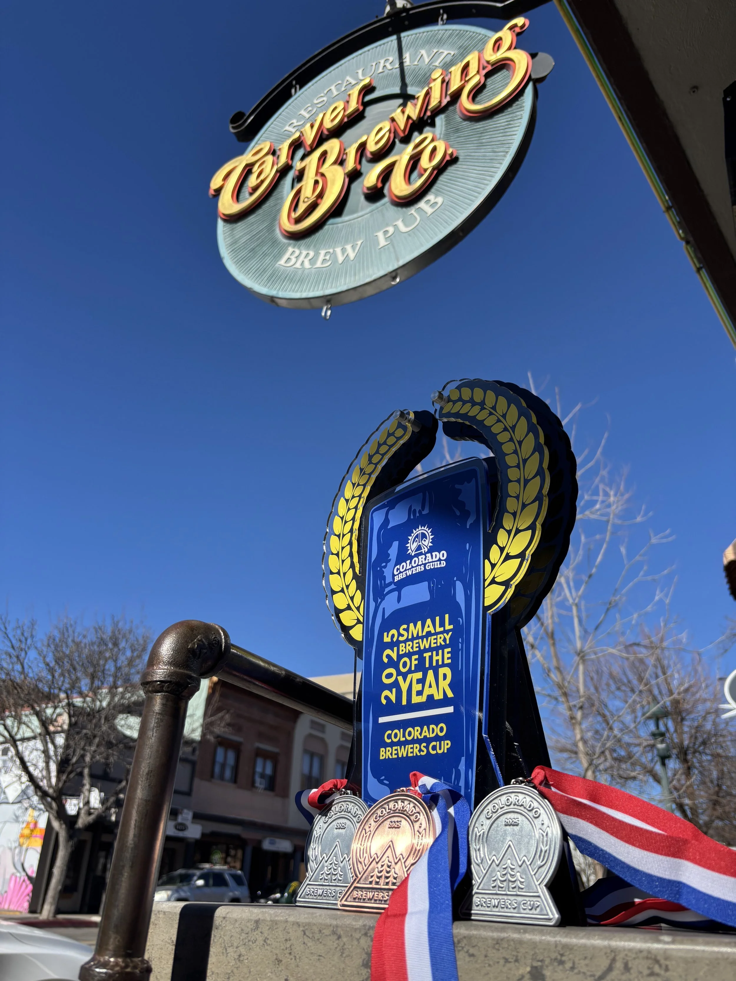 Carver Brewing Company's awards displayed under their sign