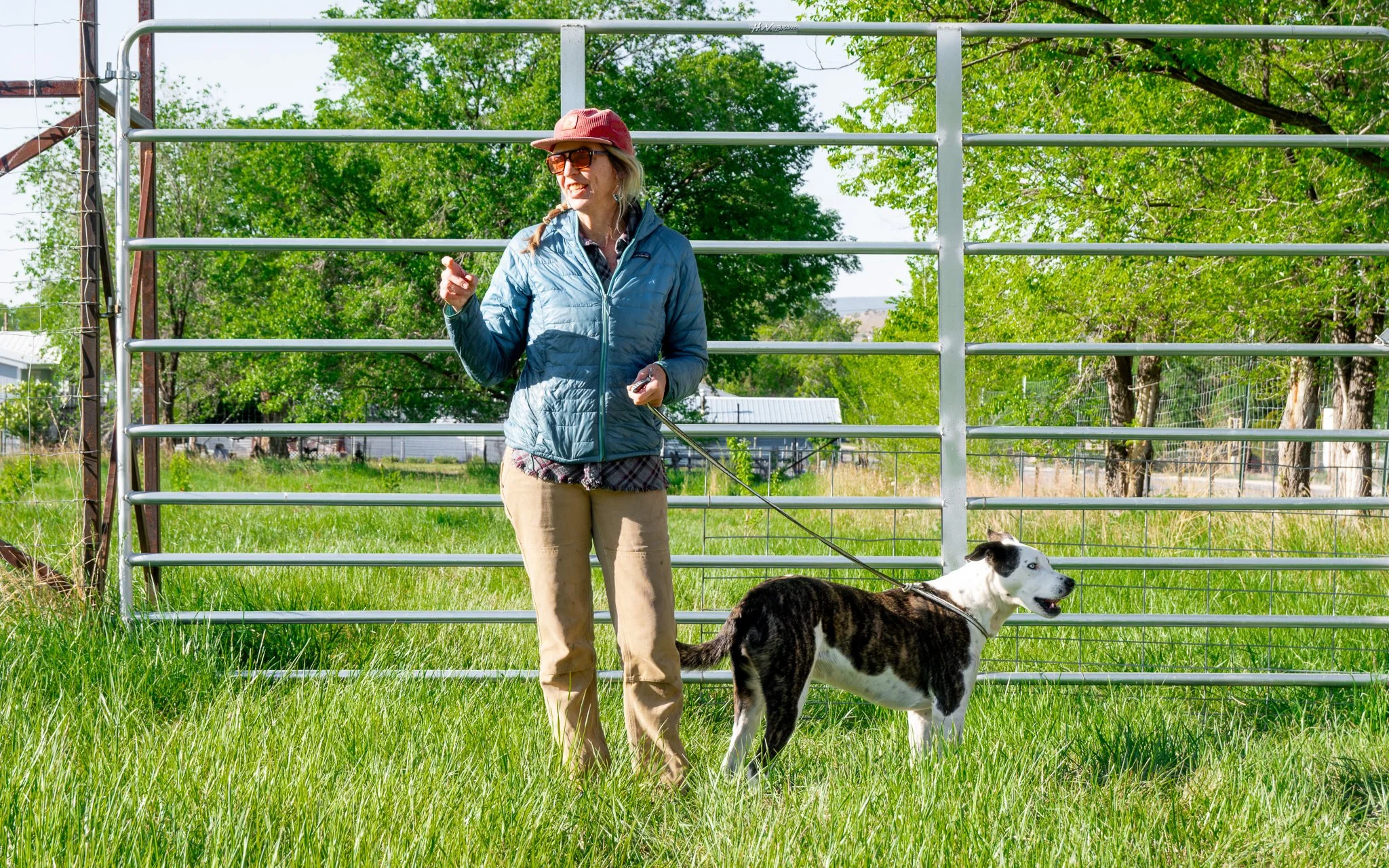 Melanie Eggers stands with a farm dog