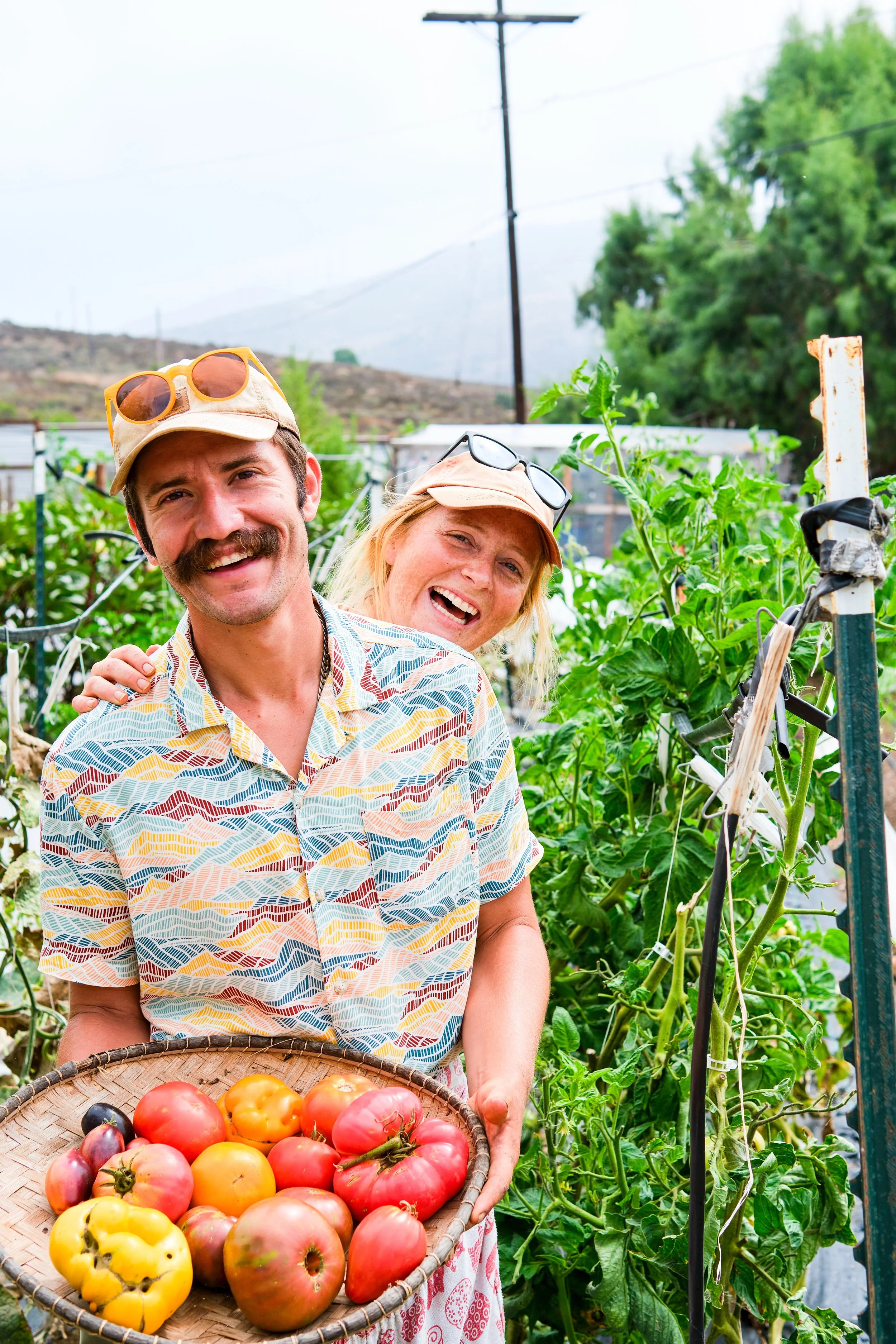 Alyssa and Christian of Ranchito Milkyway with a basket of heirloom tomatoes
