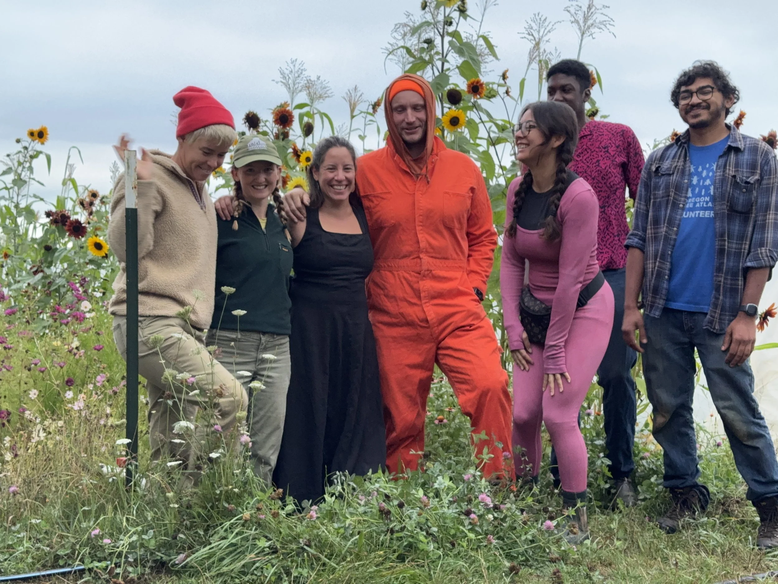 A group of of farm staff gathered in field