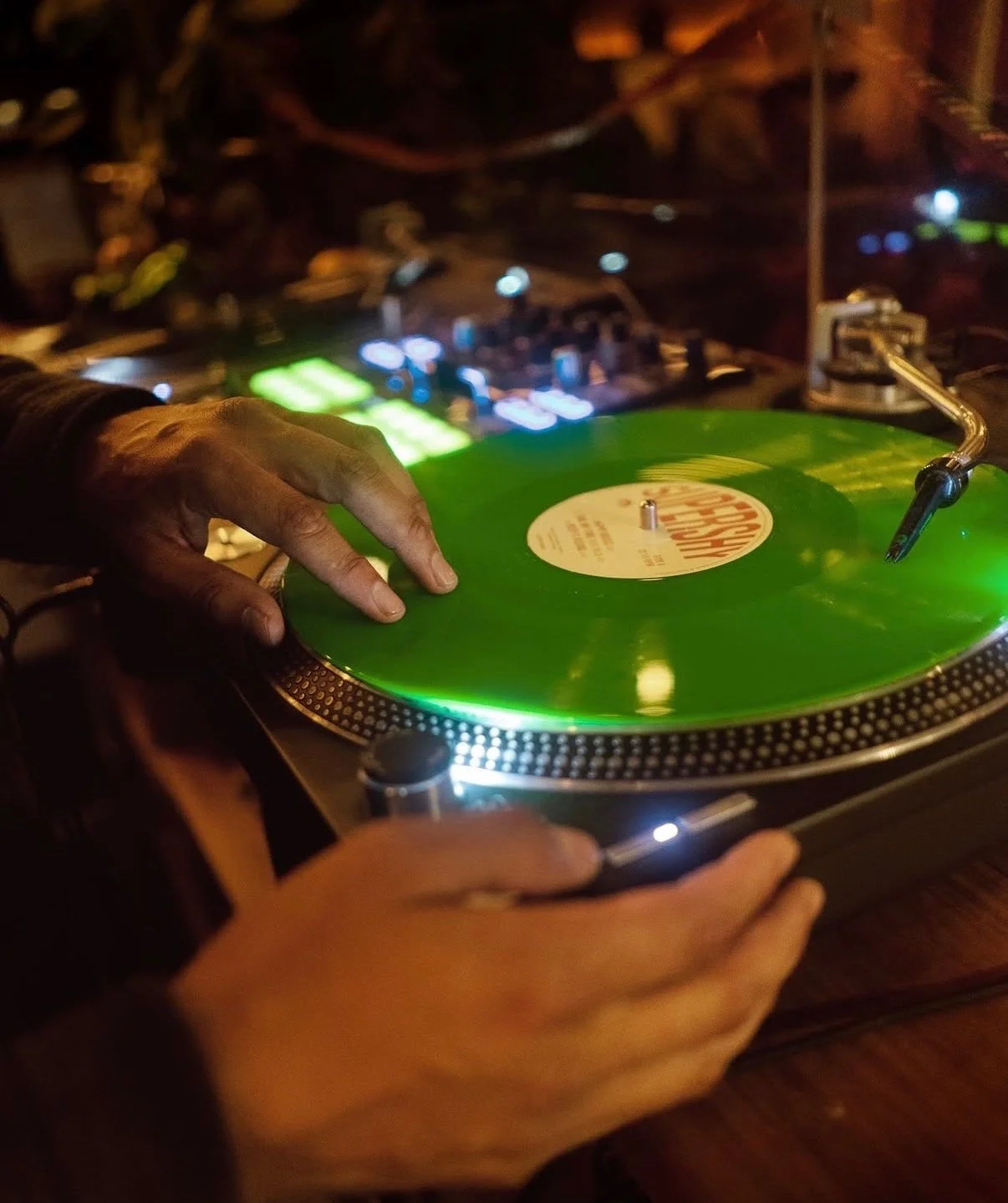 A vinyl record is spun on the DJ booth at Sonder