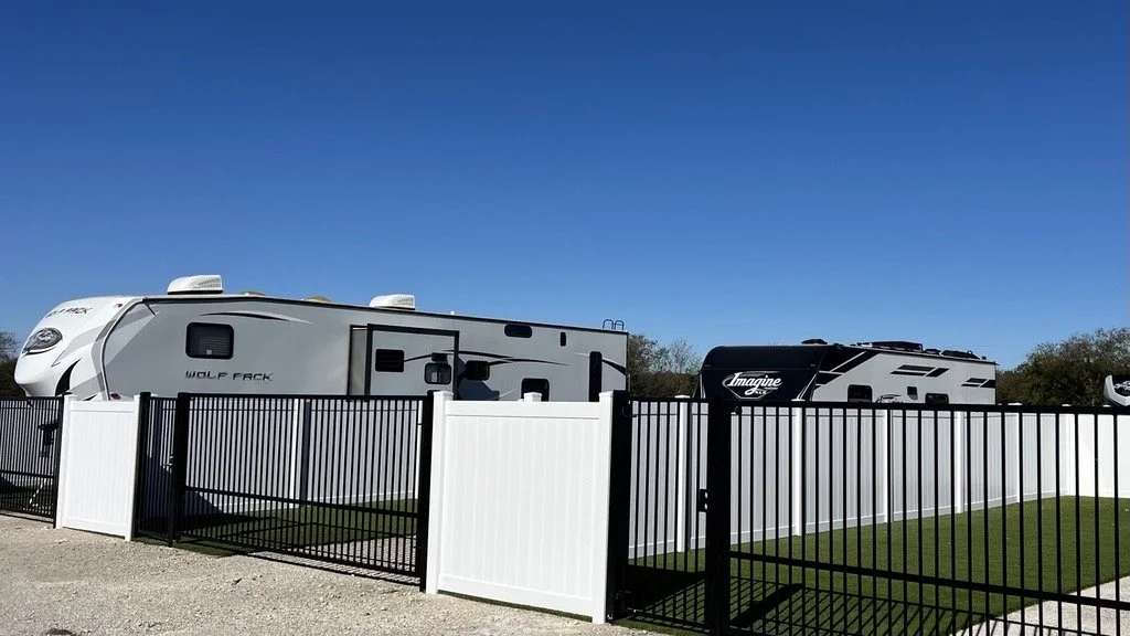 RV trailers parked beside private fenced lots at NorthStar RV Park.