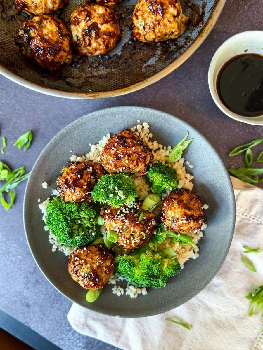 baked turkey meatballs with sticky glaze // overhead shot with steamed broccoli and cauliflower rice