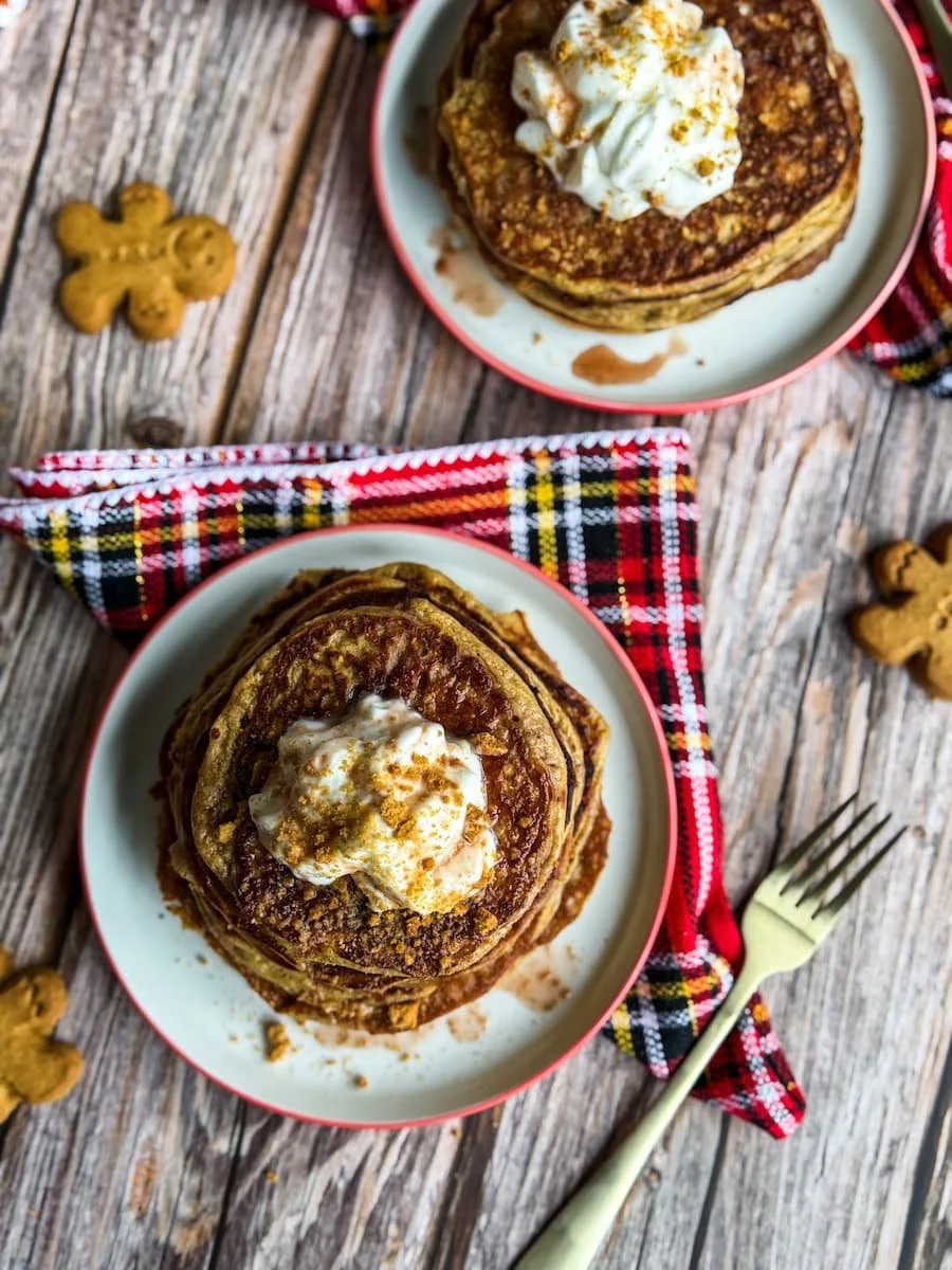 overhead shot of two stacks of gingerbread protein pancakes on plates / protein pancake recipe