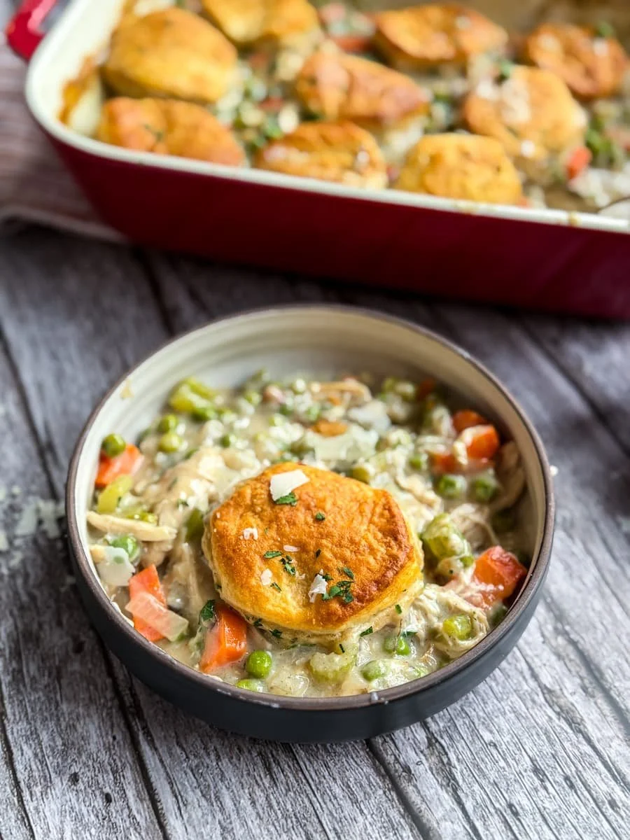 close-up shot of a portion of chicken pot pie casserole in a bowl / shredded chicken recipes