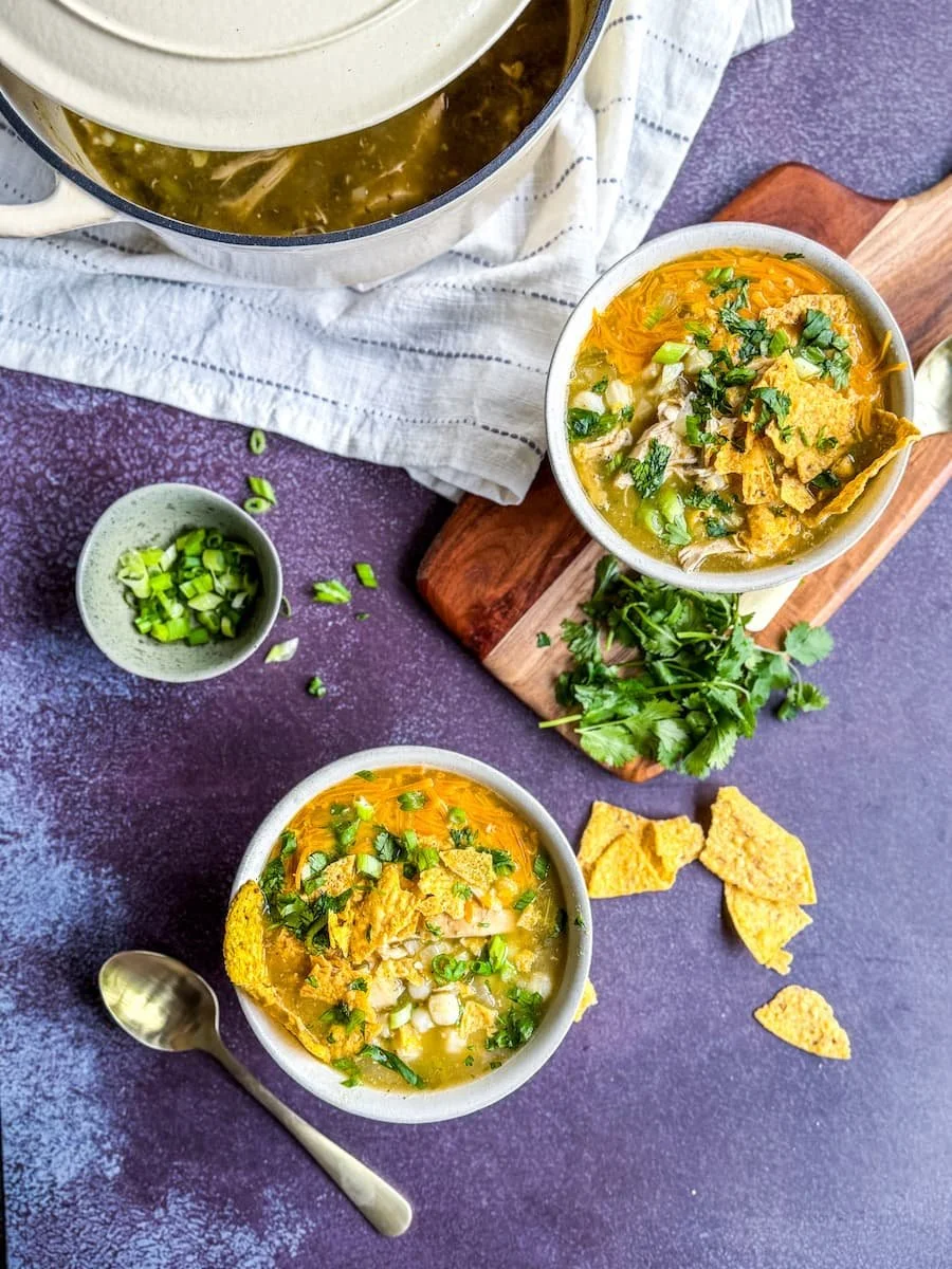 what is pozole / pozole verde - two bowls of finished pozole with the pot of soup in the background