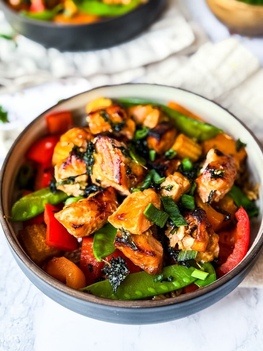 salmon air fryer recipe - close-up shot of finished honey garlic salmon with vegetables and rice