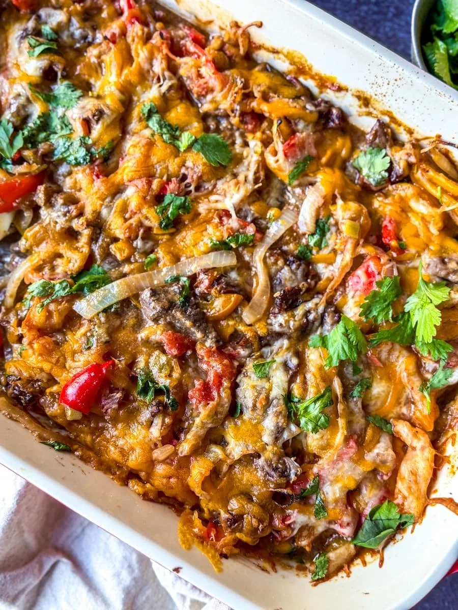 steak fajita casserole garnished with fresh cilantro