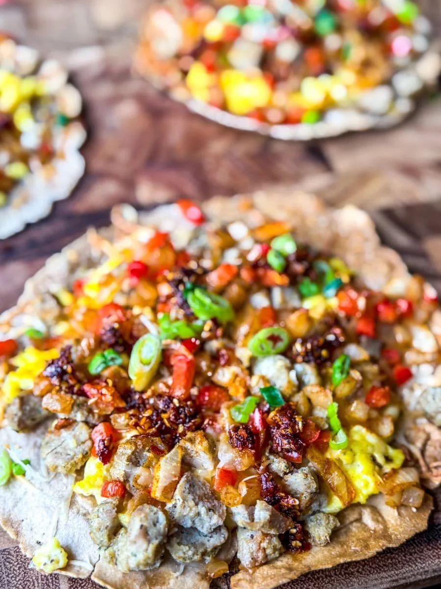 close-up photo of a breakfast tostada topped with chili cris