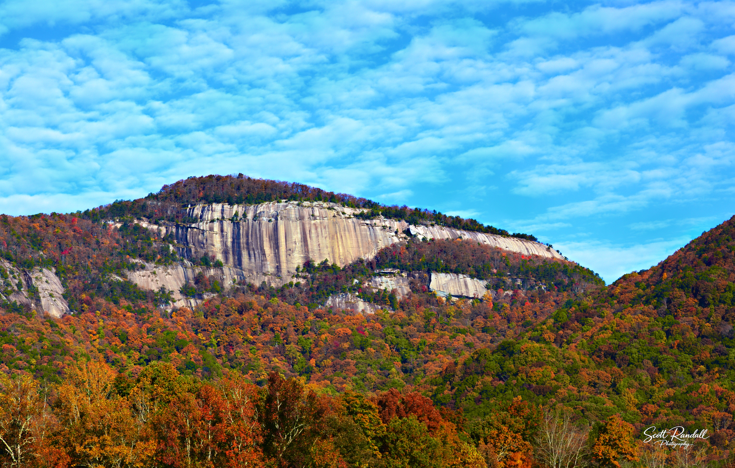 "Fall At Table Rock". Beautiful sunny fall day at Table Rock, SC.  The clouds were making a great pattern on this day, and the contrast with the blue sky and the trees was beautiful.