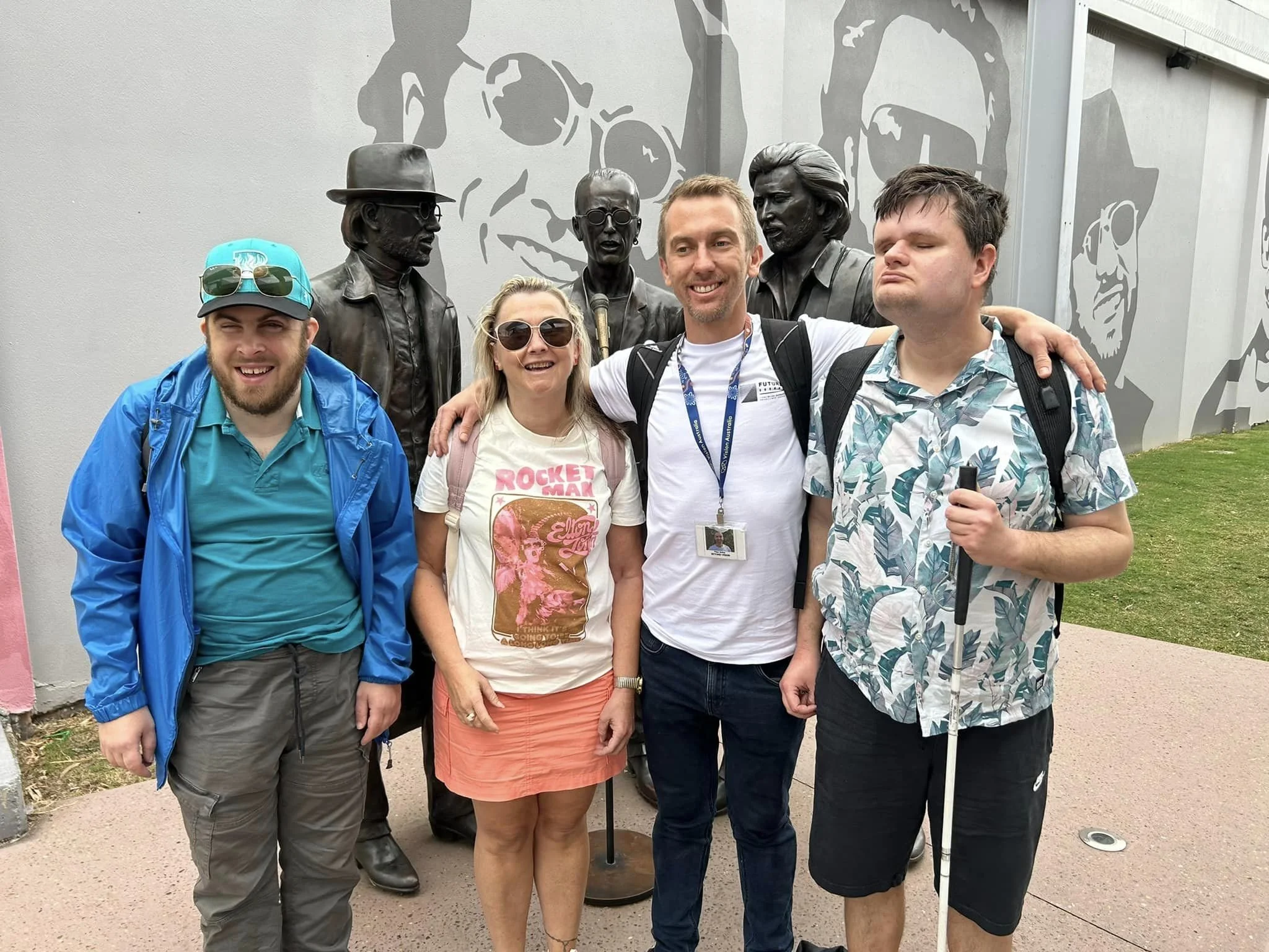 Peter and clients in front of Bee Gees statue