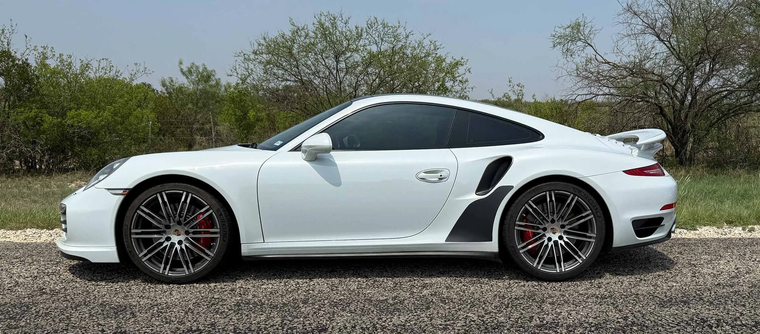 Pano-Wht-991-turbo-side-on road-black-matgnetic-stone-gurads.jpg