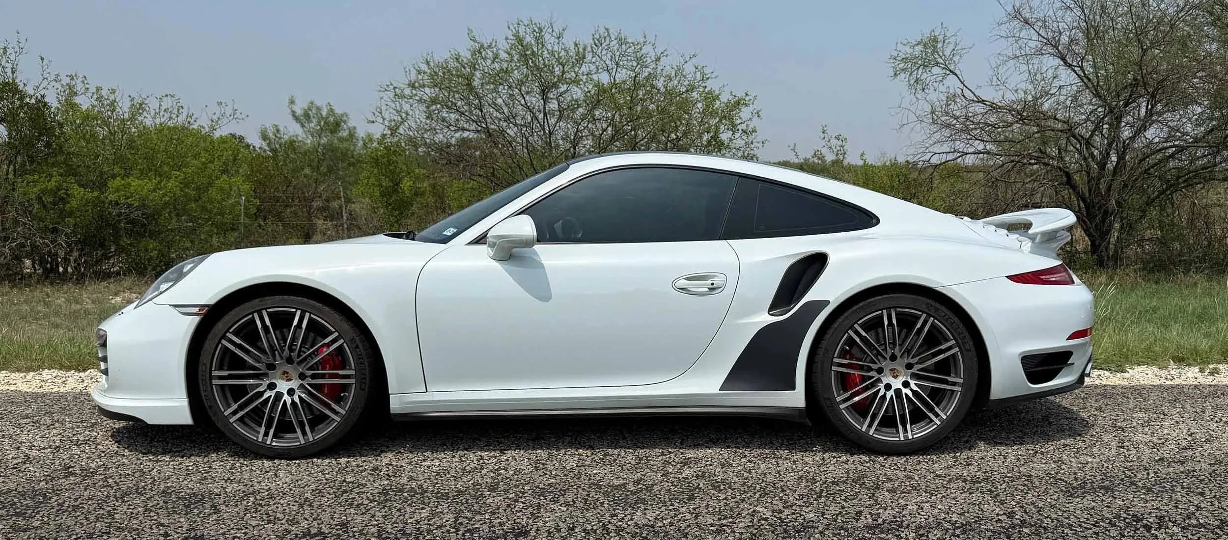 Pano-Wht-991-turbo-side-on+road-black-matgnetic-stone-gurads.jpg