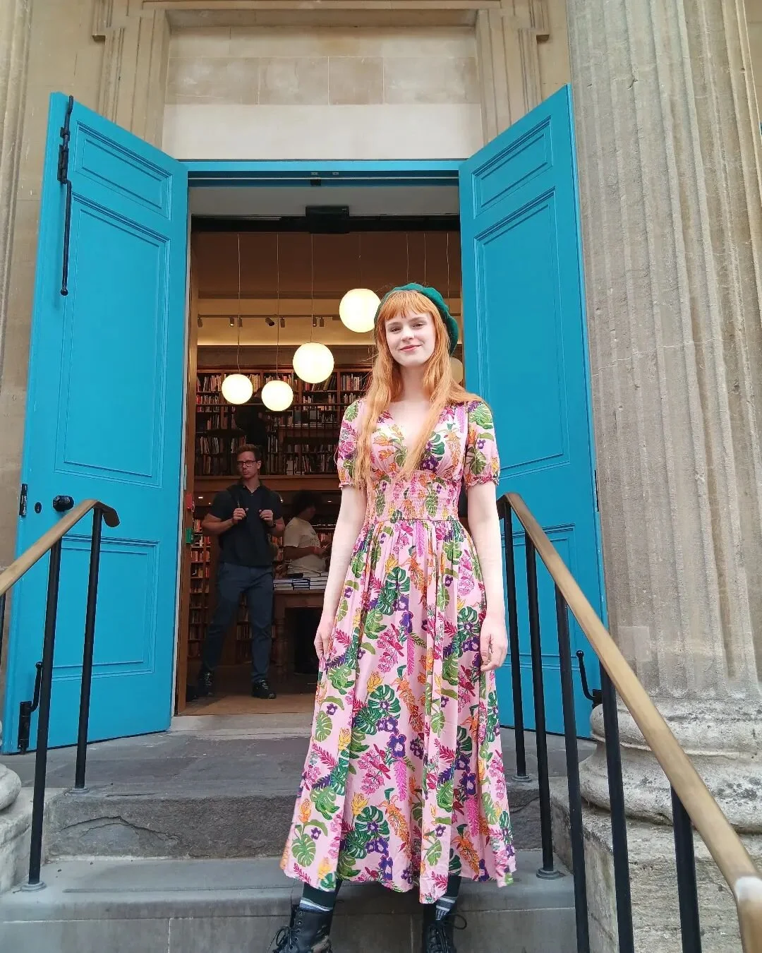 'I'm just a girl, standing in front of a bookshop, asking for it to please be having a half-price sale on Penguin Clothbound Classics.'

Image description:
The image is of Anna, a white femme person with long ginger hair, standing on the steps in fro