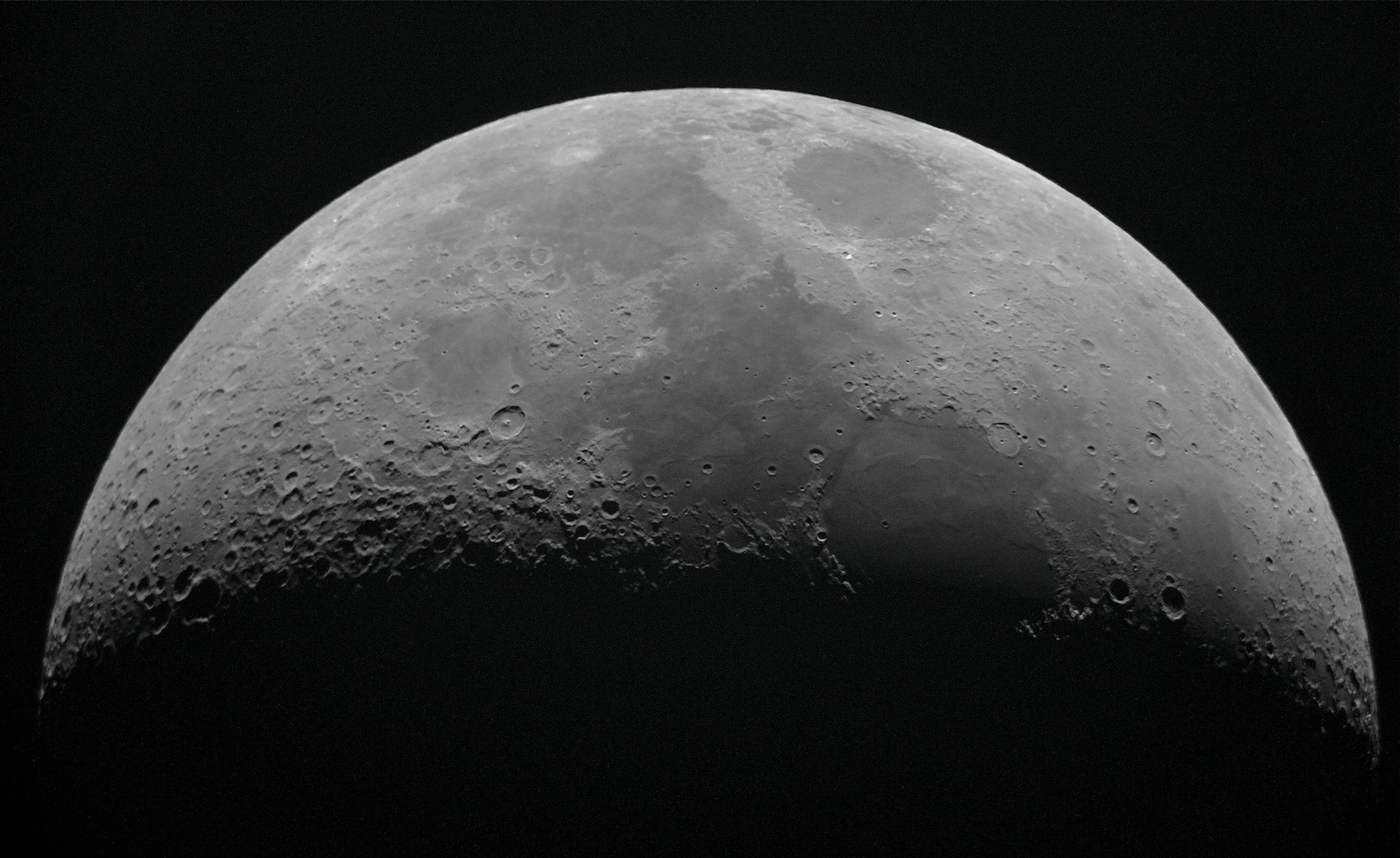 Close-up photograph of the moon showing craters and surface details against the darkness of space.