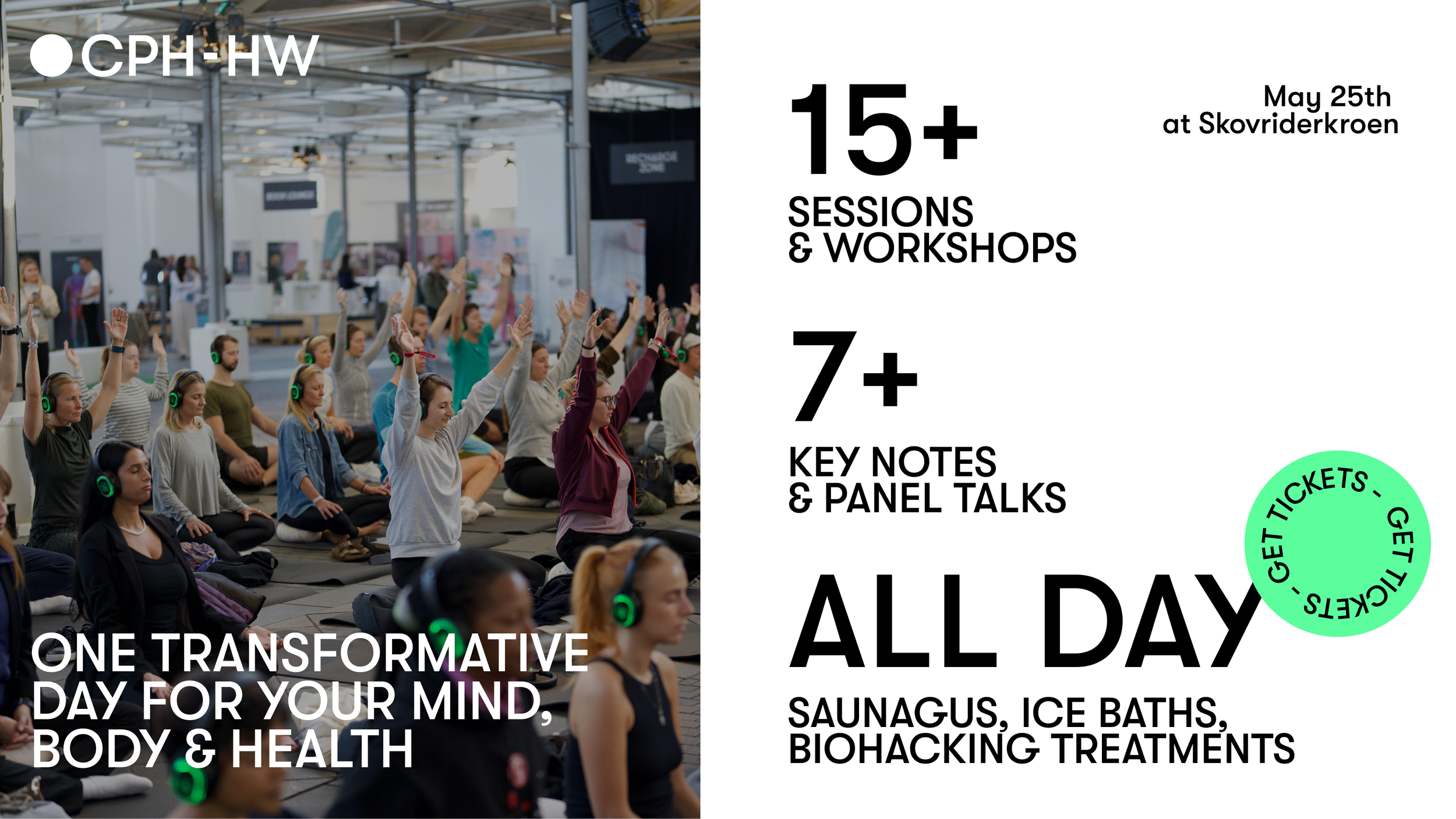 Folk deltager i en yogaklasse eller mindfulness session, hvor de sidder på gulvet med hænderne i vejret, alle med hovedtelefoner, i en stor indendørs konferencehal.