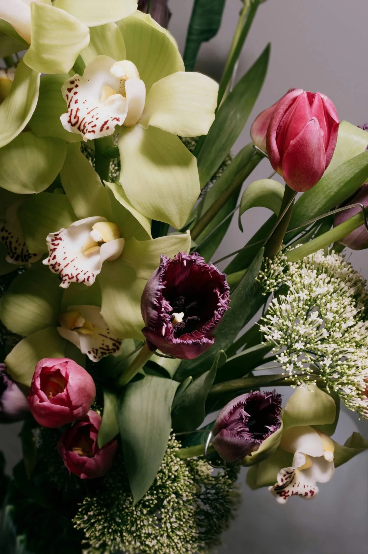 Fresh Flower Arrangement for Event Decor - A vibrant bouquet featuring tulips and orchids, perfect for event decoration.