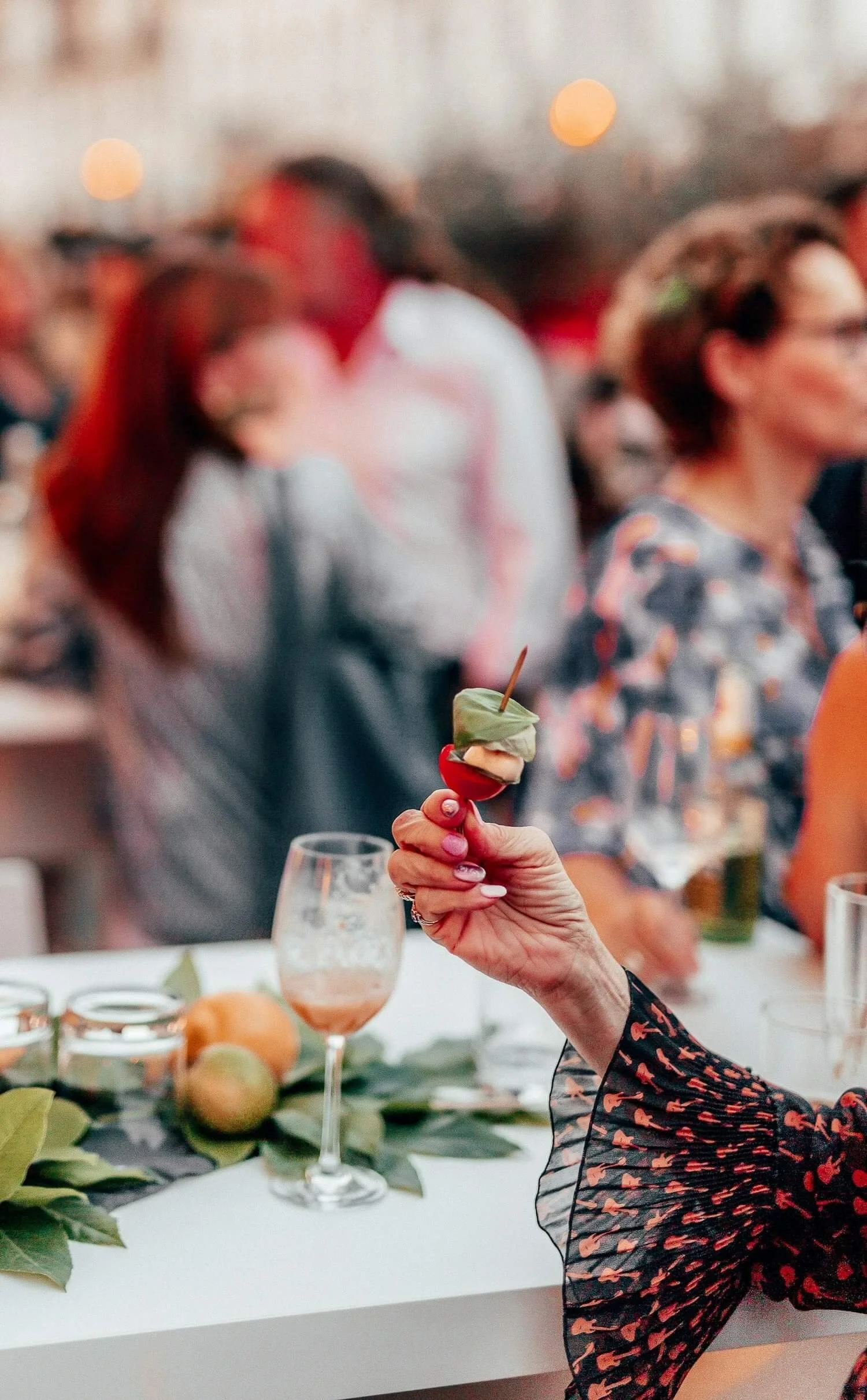 People Enjoying Reception at Skovriderkroen - Guests interacting with food and drinks at a stylish reception setting at Skovriderkroen.